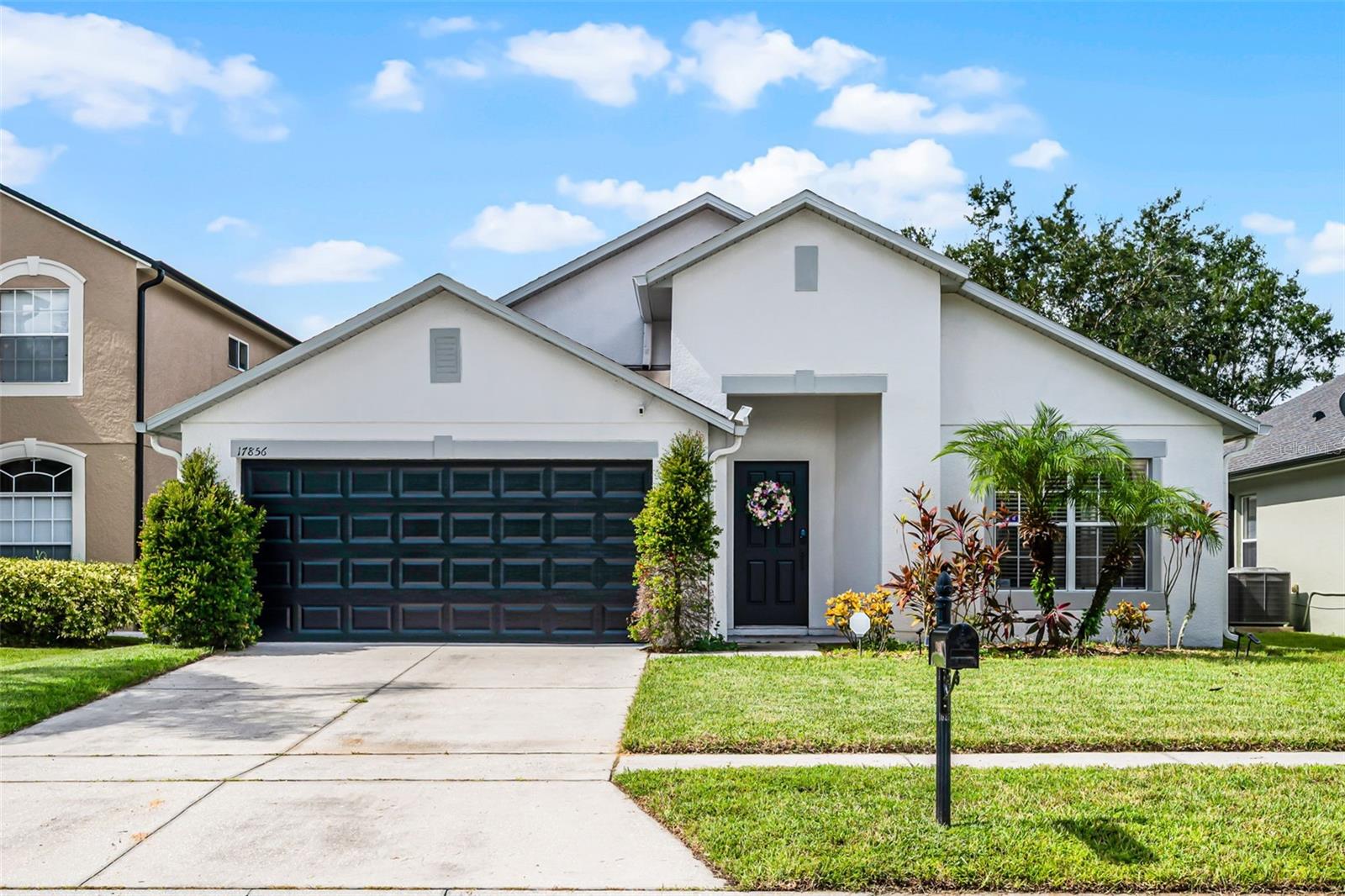 This beautifully remodeled single-family home offers 4 spacious bedrooms, 2 bathrooms, and an open one-level floor plan designed for both comfort and style. Step inside to discover wood-look tile flooring throughout, high ceilings, recessed lighting, and abundant natural light from the many windows with blinds already in place. The front of the home provides a flexible formal living and dining space, while the separate family room with sliding doors opens directly to the backyard patio—perfect for indoor/outdoor living. The renovated kitchen is a chef’s dream, featuring quartz countertops, a striking hexagon tile backsplash, island, included appliances, and cabinets with crown molding. A built-in wine bar with a wine rack adds a touch of luxury, while the convenient laundry room includes a washer and dryer. Both bathrooms have been fully remodeled with quartz countertops, modern rectangular vessel sinks, sleek black hardware, LED lighted mirrors with adjustable lighting and anti-fog features, tiled shower walls, frameless glass showers, and dual shower heads allowing for handheld or wall mount use. The luxurious primary suite is a true retreat, showcasing dual sinks, an oversized frameless glass shower with niche, black fixtures, and a bidet toilet. Enjoy a private backyard with a white PVC fence and a patio area ideal for relaxing or entertaining. Other great features include: 2-Car Garage with Tesla Charger, 6-Panel Doors with new black hardware, updated Light Fixtures, Ceiling Fans, Tankless Water Heater, AC System (2023), Gutters, NEST Thermostat, RING Doorbell, and Security System. Cypress Lakes offers unmatched amenities, including a state-of-the-art clubhouse, fully equipped fitness center, resort-style pool, splash pad, playground, dog park, tennis, pickleball, and basketball courts. Served by well-rated schools and centrally located with easy access to major highways, Orlando International Airport, Downtown Orlando, UCF, Research Parkway, and Waterford Lakes Town Center. Everyday conveniences such as a supermarket, pharmacy, gas station, and restaurants are just minutes away. This home perfectly combines modern upgrades and a resort-style community lifestyle. Don’t miss your chance to call this Cypress Lakes beauty your new home!