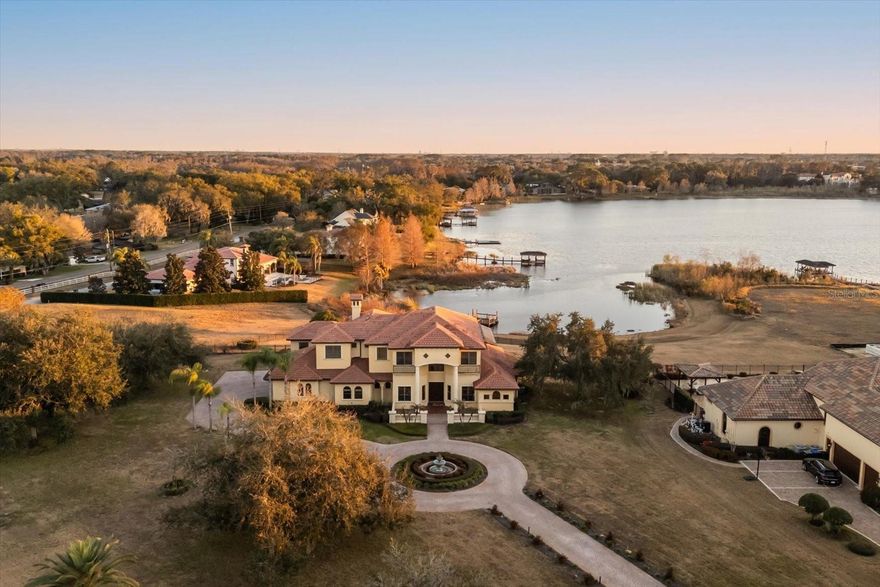 Nestled within one of **Windermere**’s most exclusive communities, this extraordinary custom-built lakefront estate with an almost 2 acres lot offers an elegant lifestyle defined by privacy, prestige, and breathtaking nightly views of the **Walt Disney World** fireworks. With nearly 6,000 square feet, six bedrooms, and six and a half baths, this residence is the pinnacle of refined Central Florida living.

A long, winding driveway welcomes you, framed by mature trees and sweeping lawns. Tucked away on a quiet cul-de-sac within a 24-hour guard-gated neighborhood with a manned guard station, the property offers both grandeur and seclusion — a rare combination in today’s luxury market.

Thoughtfully designed to maximize natural light and panoramic water views, the home features soaring ceilings, expansive picture windows, and seamless indoor-outdoor flow. The grand foyer opens to a spectacular living room anchored by tranquil lake vistas. The chef’s kitchen is appointed with custom cabinetry, high-end appliances, and an oversized island, effortlessly connecting to spacious dining and living areas — ideal for both intimate evenings and large-scale entertaining.

The primary suite, located on the main level, is a private sanctuary with serene lake views and direct access to the outdoor living areas. The spa-inspired bath offers a soaking tub, dual vanities, walk-in shower, and generous closet space. Four additional bedrooms of which two of them include their own en-suite bath, ensuring comfort and privacy for family and guests.

A detached in-law suite with private entrance, living area, bedroom, and bath provides exceptional flexibility for multigenerational living, long-term guests, or a private executive office.

Step outside to your own outdoor oasis. The resort-style pool overlooks the lake, creating a stunning backdrop for entertaining or quiet relaxation. A charming pool house complete with a Murphy bed offers additional guest accommodations and enhances the estate’s resort-like ambiance. At the water’s edge, a private dock provides access to a private ski lake — perfect for boating, skiing, paddleboarding, or sunset cruises.

As evening falls, the magic begins. From your backyard, dock, or expansive windows, enjoy nightly fireworks illuminating the sky above Disney — a spectacular private show reflected across the water. With nearly two acres of lakefront land, six bedrooms, six and a half baths, a detached suite, pool house, long private driveway, and location within one of Windermere’s most prestigious guard-gated communities, 12720 Jacob Grace Ct is more than a home — it is a destination, a sanctuary, and a stage for life’s most extraordinary moments.