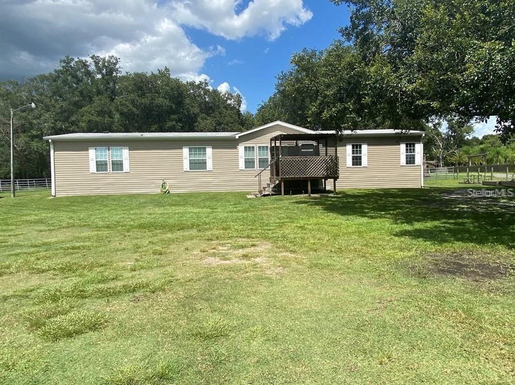 Beautifully maintained and updated 4-bedroom, 3-bathroom manufactured home available in Kissimmee. This 2,300+ sqft home features an open concept with a kitchen/family room/dining room combo! With over 2,300SF inside you have plenty of space for family and friends! Outside, enjoy the privacy this property provides while sitting on over 10 acres. This home is also conveniently located, only minutes away from all of the shopping in Kissimmee!
The barn can also be leased seperately of in addition to the manufactured home. This would be a great property to keep horses or any farm animals. This land would be used for agriculture. To lease the 4-bedroom house is $2500/monthly; the barn is $2000/monthly. Together $4000/monthly; $500 discount for both.