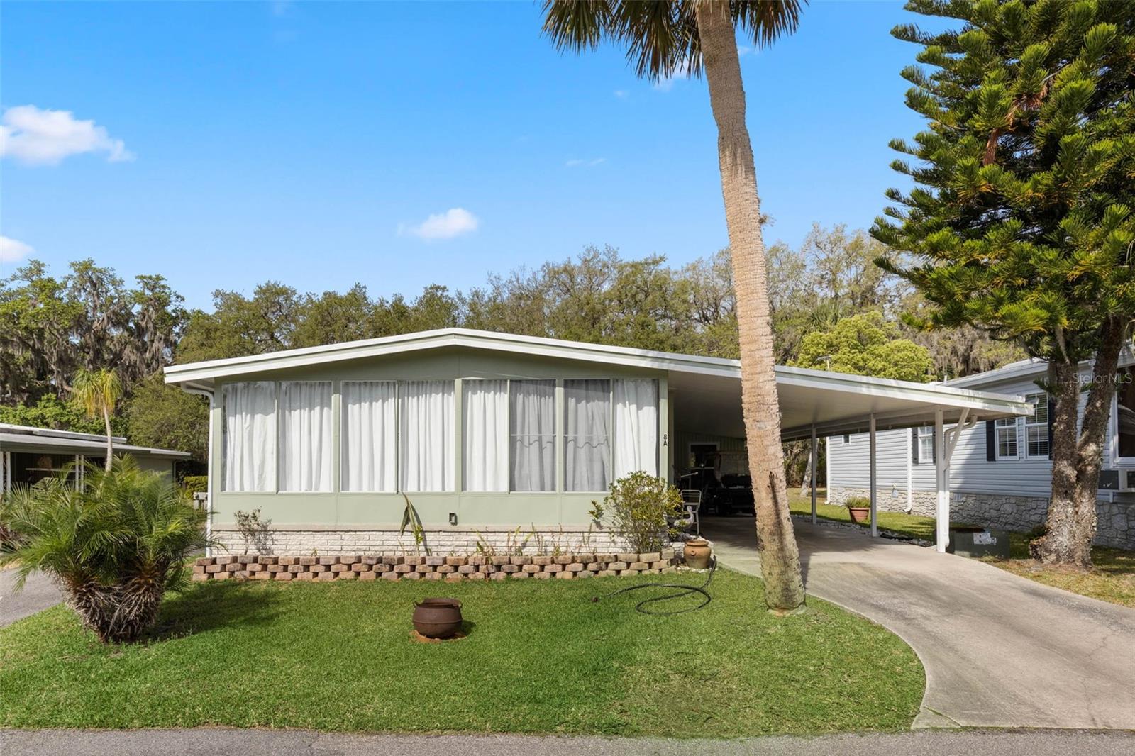 This Home is Located in 55 + Community of Eustis Country Club Manor. This Home features a 2 Bedroom, 2 Full Bathroom Home. The HUGE Florida Room that you first walk into it adds a ton of space for all your storage needs. The Living Room features an Open Floor Plan into the Kitchen and Dining Room. The Primary Bedroom features Three Closets with a ton of space for all your storage needs. The Primary Bathroom features a walk in shower. The Second Bedroom features Great Space for Guests. The Second Bathroom features a Tub with Shower. The homes features an outside shed storage with the washer and Dryer. The Home is being Sold Furnished. This home is being sold with a Co-op Share (which is valued at $30,000 that is included in the sale). It offers a lot of amenities for $231.00 per month which includes a community pool, shuffle board, Recreational facilities, sewer, trash, water, and a private boat ramp. The community features a beautiful Clubhouse which features a Variety of Activities which include Bingo, Special Occasion Events for Holidays, Bridge, Pot Luck Dinners, and a ton of other activities. Come and See Today !