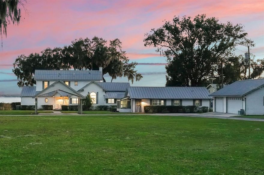 Big Lake Weir, north shore Paradise only 15 min. north to Ocala or 15 min. to The Villages!  Indulge in this 2.45 Acre private, gated lakefront estate with 160 ft of soft white sand beach.  This 5 BR/5.5 bath, 3,946 SF main home was classically and tastefully renovated with features that are impressive throughout with unparalleled quality construction, state of the art amenities and stunning interiors.  Enjoy the sunrises and sunsets over the lake on the huge back porch or move on to the class A boat-cabana house over the water.  There is nothing like enjoying a delicious dinner at one of the lakeside restaurants by boat after a day of water activities right in your own backyard or just a day reading in the hammock.  Covered walkway leads from main home to 1 BR/1 Bath cottage/guest house with full kitchen, living area, bath, sunroom, and the 3-car garage.  Additional two cars accommodated in tasteful, detached, covered parking next to main home.  This private estate is the ultimate dream – see attached detailed feature list.
