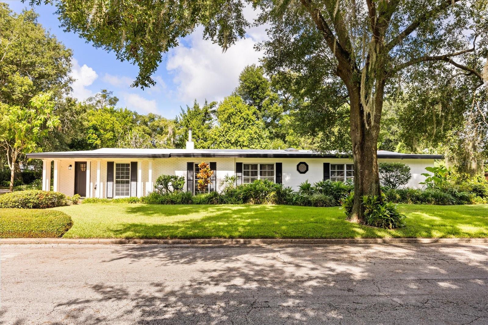 One or more photo(s) has been virtually staged. **This house comes with a REDUCED RATE through the seller's preferred lender. This is a lender-paid rate buydown that reduces the buyer's interest rate and monthly payment.**Welcome home to this beautifully renovated 4-bedroom, 2-bathroom home nestled on a desirable corner lot in the heart of Winter Park’s Timberlane Shores community. Boasting modern upgrades throughout and zoned for top-rated schools, this move-in-ready gem offers comfort, charm, and convenience just steps from Blue Jacket Park. Make your way inside to discover brand new luxury vinyl plank flooring that flows seamlessly through the open-concept layout. The front entry opens into a spacious formal living and dining area, leading into a stunning chef’s kitchen. This fully updated kitchen features quartz countertops, a large central island with range and hood, sleek top of the line stainless-steel appliances, and a playful pantry door that doubles as a secret entry into the laundry room and oversized two-car garage. Beyond the kitchen, French doors lead into the main living room, highlighted by an elegant fireplace and oversized plantation-shuttered windows that flood the space with natural light—offering plenty of room for the whole family to relax, gather, and spread out in comfort. Just off this living space is a versatile flex room, ideal for a home office, playroom, or even a fifth bedroom. Down the hallway, you’ll find three guest bedrooms and a full bath. The primary suite at the end of the hall is a true retreat, offering two walk-in closets, a luxurious ensuite with a double sink vanity, a separate makeup vanity, and a walk-in shower. The home sits on a large, well-landscaped corner lot with a private backyard accessed via the flex room—perfect for entertaining, relaxing, or enjoying the Florida sunshine. Location is key! Right out your front door there is access to a quaint neighborhood park/green space and you're across the street from Blue Jacket Park! A short drive takes you to East End Market, the shops and dining on Corrine Drive, downtown Winter Park, Baldwin Park and the Audubon Garden District. Zoned for Audubon Park K-8 and Winter Park High School, this home offers the total package—style, space, and top-tier schools. Don’t miss your chance to own this exceptional home in one of Central Florida’s most sought-after neighborhoods.