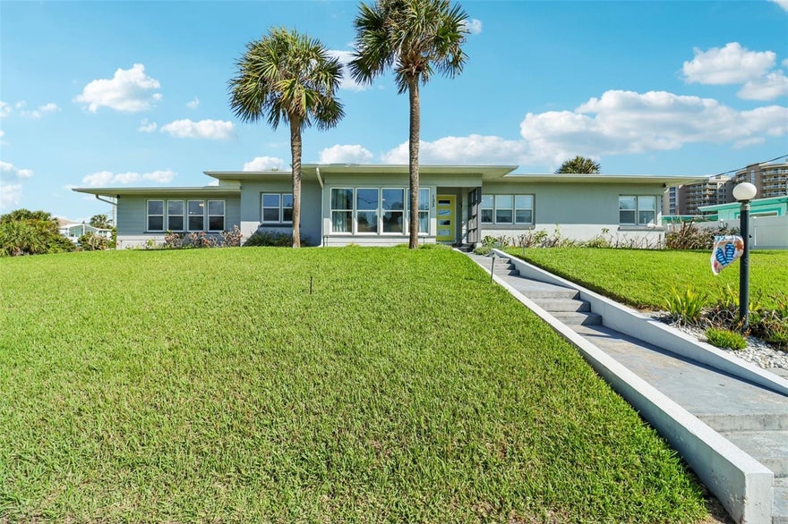 Renovated coastal home located just steps from the beach. This 3 bedroom, 2 bathroom property sits elevated and offers ocean views from the front yard and main living area, including sunrise views over the ocean from the living room. Positioned only four homes from A1A, this location delivers easy beach access without direct oceanfront pricing. Move in ready with a clean mid century modern design, the interior features a bright, updated kitchen with strong natural light and an open feel throughout the main living spaces. A flexible bonus area functions well as a home office or additional family room. Inside utility adds convenience for daily living. The home sits high and dry on a large corner lot with a fenced backyard and irrigation system already in place. Exterior highlights include a 2 car carport, outdoor shower for post beach use, and dedicated storage space for surfboards, bikes, and beach equipment.

Enjoy unique coastal benefits such as shuttle launch viewing from the front step along with consistent ocean breezes and elevated positioning. Strong opportunity for primary residence, second home, or investment property in a high demand coastal market!