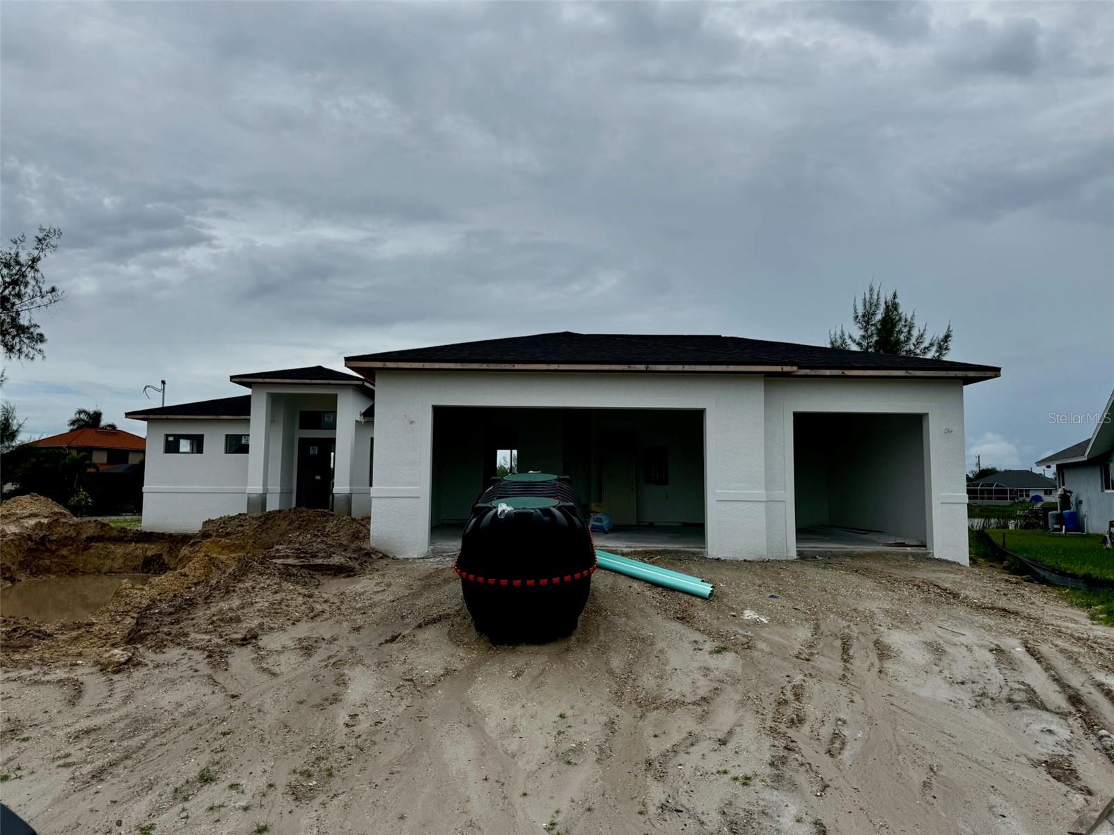 Under Construction. Interior access not permitted. This stunning under construction home in Cape Coral is nestled in a family-friendly neighborhood. Enjoy spectacular lakefront views from your backyard, complete with a sparkling pool, seawall and dock in place - perfect for entertaining. Luxurious open and modern floor plan. The home also boasts a 3-car garage with more than ample storage and parking, along with a stylish paver driveway. A truly exceptional property for those seeking modern comfort and elegance. Interior access not permitted. Please view from street.
Project completion date is estimated and subject to change.