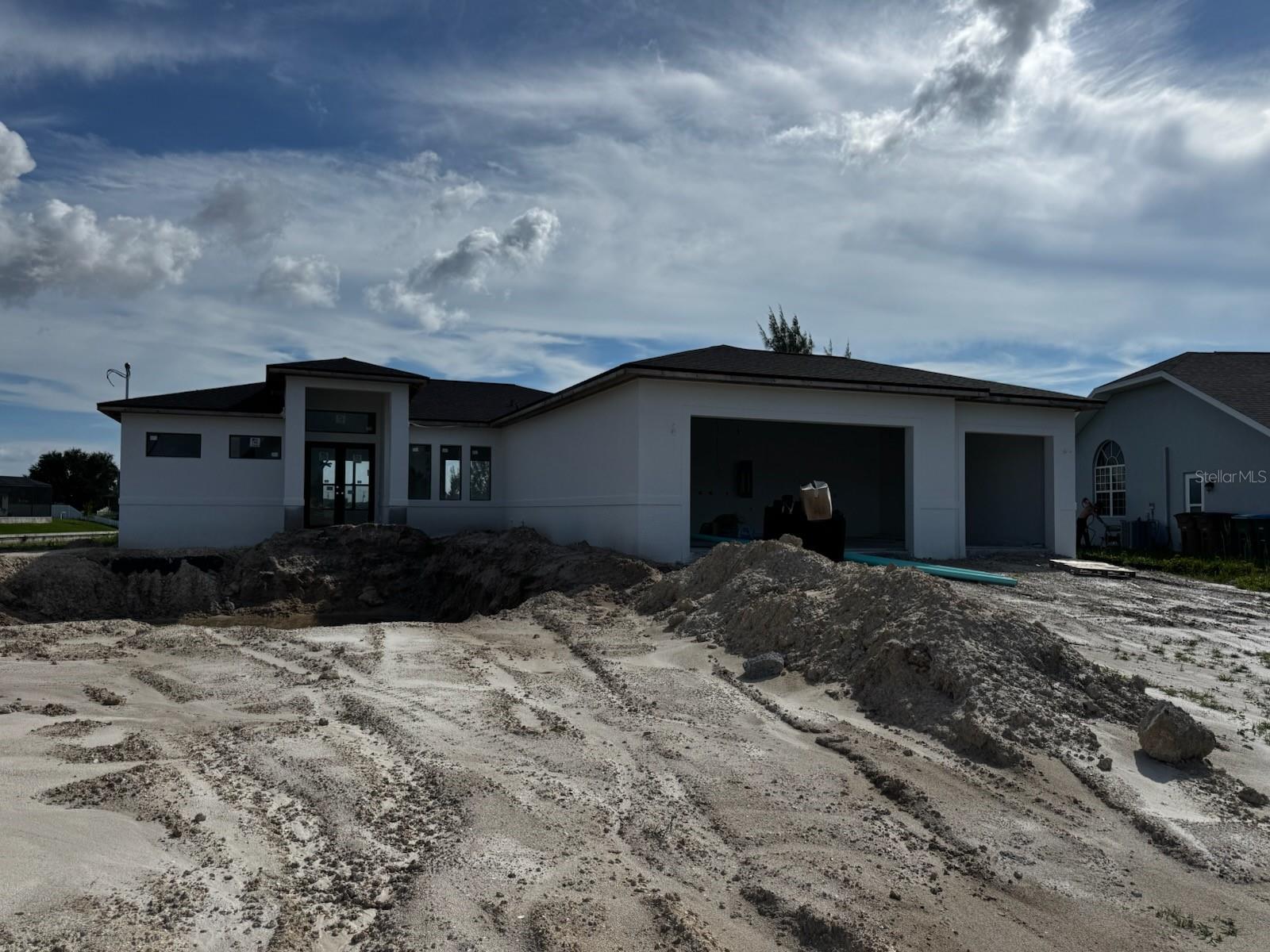 Under Construction. Interior access not permitted. This stunning under construction home in Cape Coral is nestled in a family-friendly neighborhood. Enjoy spectacular lakefront views from your backyard, complete with a sparkling pool, seawall and dock in place - perfect for entertaining. Luxurious open and modern floor plan. The home also boasts a 3-car garage with more than ample storage and parking, along with a stylish paver driveway. A truly exceptional property for those seeking modern comfort and elegance. Interior access not permitted. Please view from street.
Project completion date is estimated and subject to change.