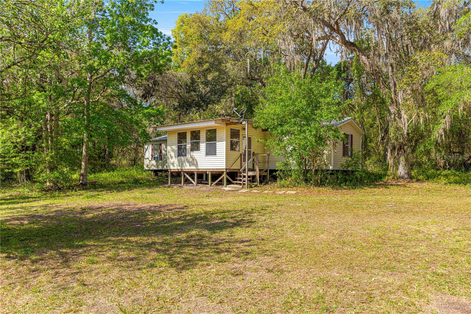 Own your piece of a Sportsman's Paradise. 1/2 acre lot with a single wide mobile with potential in Forest Lakes Park. Property overlooks Silver Lake, and is a short walk to the Ocala National Forest. Wild life abounds out here with regular sightings of White Tail deer, Boars, Wild Turkeys and an amazing abundance of birds from Cardinals to Sand Hill Cranes. There is a 12 x 24 wooden shed for all your toys. Metal roof is 6 years new. Bring your offers!!