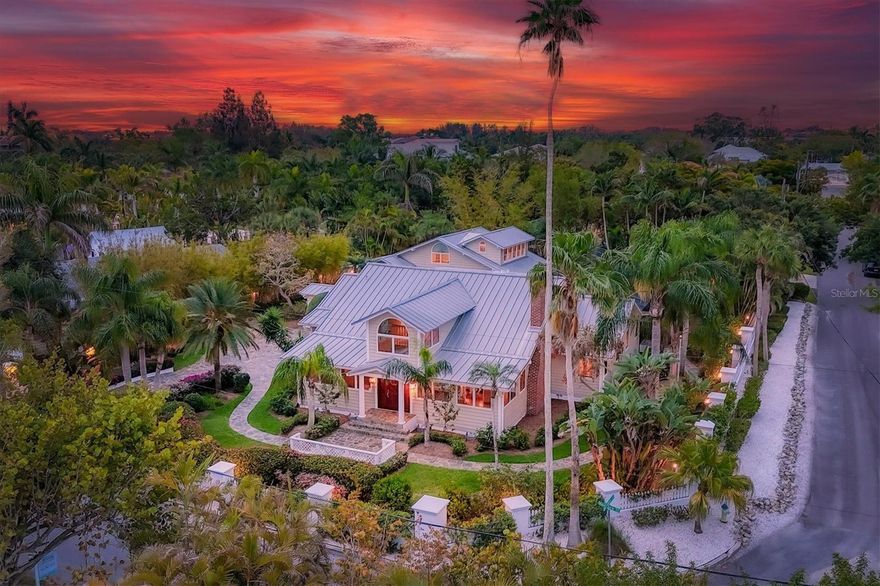 Welcome to 604 Norsota Way, a slice of Florida paradise on Bay Island, just off the iconic barrier island Siesta Key. This charming estate boasts classic and timeless elegance, offering a glimpse into the quintessential Florida lifestyle. As you approach the entrance, a slate stone driveway, a fenced yard, a wall that wraps the property, lush landscaping and water views set the stage for the ambiance and seclusion that awaits. Stepping inside, you are greeted by a foyer that exudes old-Florida charm, with a soaring entry and upper-level windows casting a soft glow over the inviting interior and a wall of front windows offers breathtaking views of the bay. The living room is a retreat with a cozy fireplace and the adjacent dining area includes a fully equipped pass-through wet bar connecting the space to the kitchen. The kitchen is a chef's dream with tray ceilings, tile floors, a center island with gas cooktop, a cabinet-faced refrigerator, built-in oven, glass-faced upper cabinets, a wet bar, beverage cooler, ice maker, and trash compactor bringing together modern convenience and timeless charm. The primary suite is a sanctuary of comfort and elegance featuring wood floors, crown molding, a sitting room and a custom walk-in closet. The en-suite bath is a spa-like retreat, with marble floors, a walk-in shower, a large tub, a water closet, and vanity with two sinks and a makeup desk. Upstairs in the main house, two guest bedrooms offer cozy retreats, one with an en-suite bath with a tub-shower combination, both with walk-in closets, and an additional full bath with a vanity and a walk-in shower. Outside, the allure of Florida living continues, with a pool surrounded by a slate pool deck and lush landscaping offering a refreshing and private oasis. The charming guest house awaits friends and family, with two fully equipped guest suites, each offering a living area, kitchenette, patio on the main level and a full bath. 604 Norsota Way is more than just a home, it is a classic Florida retreat boasting original elegance and charm. Experience island lifestyle in all its glory, surrounded by modern amenities and breathtaking views, a short drive from Siesta Key’s beaches, the village and downtown Sarasota. This home is an enchanting coastal retreat.