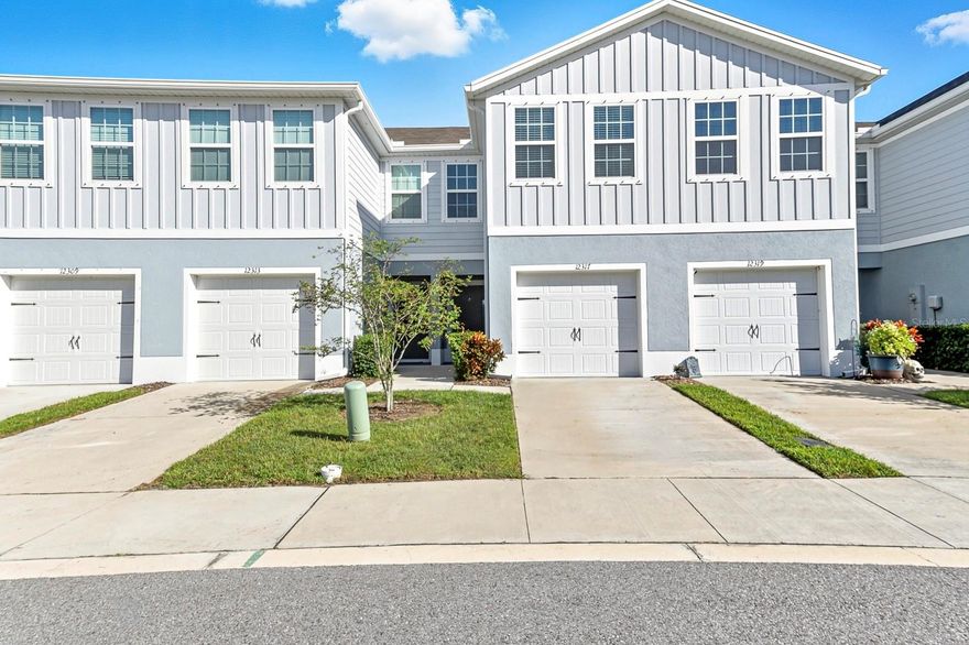 One or more photo(s) has been virtually staged. Why wait to build in a NO CDD community when you can own this like-new 2023 Ryan Homes Flamingo model with 3 bedrooms, 2.5 baths, over 1,400 sq. ft., and a 1-car garage on a beautiful pond-view homesite! This townhome is truly move-in ready and better than new! Enjoy a low-maintenance lifestyle in the sought-after Bear Creek community, offering the perfect blend of style, comfort, and convenience. The open-concept floor plan features a spacious great room that flows seamlessly into the modern kitchen, making it ideal for entertaining. The kitchen boasts a large center island, quartz countertops, modern aesthetic and design,  stainless steel appliances, and ceramic tile flooring throughout the main level. The mainfloor also features a half bathroom. Upstairs, the primary suite offers a peaceful retreat with a large walk-in closet and a private ensuite bath featuring dual sinks and quartz countertops. Two additional bedrooms, a full bathroom, and convenient upstairs laundry complete the second floor. Step outside to your screened-in covered patio, perfect for relaxing or hosting a barbecue while enjoying the tranquil pond view. Additional upgrades include LED lighting, hurricane shutters, and neutral finishes throughout. The low monthly HOA of only $186 includes cable, high-speed internet, roof and paint reserves, lawn care, landscaping, and irrigation on the front and sides. No CDD fees and no flood insurance required! Bear Creek Townhomes is ideally located just minutes from the Ridge Road Extension with easy access to the Veterans Expressway, making your commute to Tampa a breeze. Close to beaches, shopping, dining, and parks! This home truly has it all. Don't wait! Schedule your showing today! This like-new townhome will not last! Subject to 3rd party (court) approval.