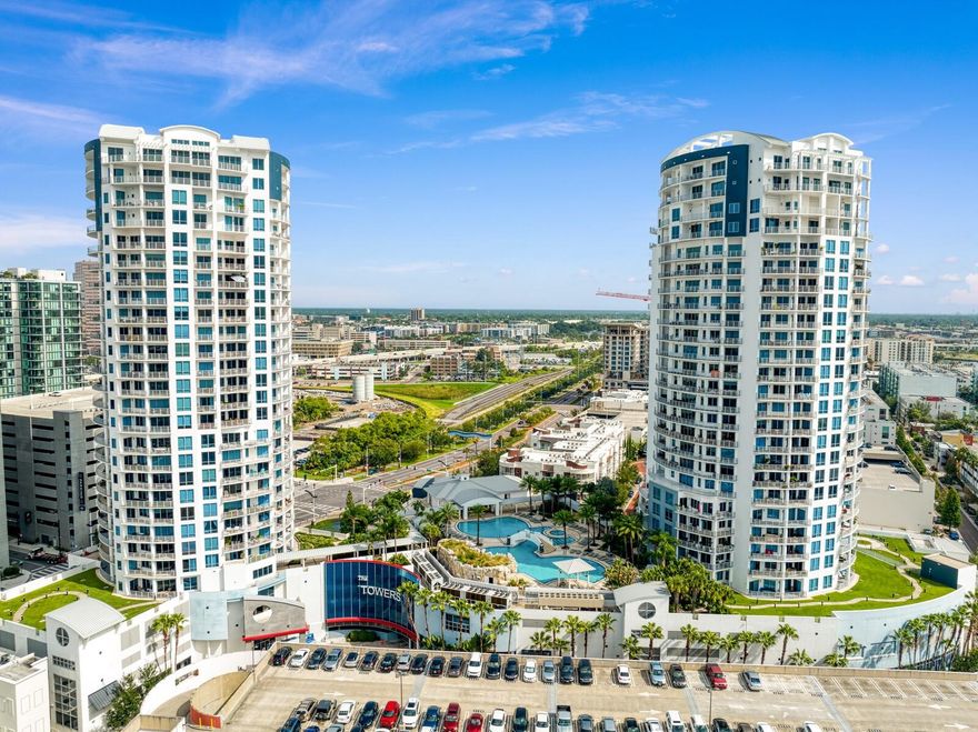 One or more photo(s) has been virtually staged. Major price adjustment-Seller Motivated! Perched high above the vibrant cityscape, this stunning new listing offers an unparalleled living experience with breathtaking sweeping water views. Immerse yourself in the essence of urban luxury with this recently updated 3-bedroom, 3-bathroom condominium on the coveted 21st floor of The Towers of Channelside.
As you step through the double front doors, you are immediately greeted by walls of windows that flood the interior with natural light, showcasing the captivating water views that stretch as far as the eye can see. The elegant travertine tile floors throughout the home add a touch of sophistication, creating a seamless flow from room to room.

The outdoor living space is equally impressive, boasting access to the balcony from all bedrooms and the great room. Step outside and indulge in the refreshing sea breeze while savoring the picturesque scenery that envelops you.

The updated kitchen is a true chef's dream, featuring the clean lines of new quartz counter tops, white contemporary cabinetry, undermount lighting and a modern design that perfectly complements the surrounding water views. 

The primary retreat is a sanctuary of its own, offering two walk-in closets with built-in features, crown molding, travertine floors, and balcony access. The en suite bathroom is a masterpiece of luxury, with upgraded white cabinets, quartz countertops, a sumptuous garden bathtub, and a separate walk-in shower.

Both secondary bedrooms boast private full bathrooms adorned with granite countertops, travertine floors, walk-in showers, and maple cabinetry, providing a comfortable and stylish space for family or guests.

The Towers of Channelside offer an array of amenities for residents to enjoy, including 24-hour security, concierge services, a resort-style pool, BBQ grills, and a clubhouse. Nestled in the heart of the trendy Channelside District, you'll be steps away from a plethora of new restaurants, Publix Greenwise Market, Sparkman Wharf, Florida Aquarium, Amalie Arena, ensuring a lifestyle that is vibrant, convenient, and filled with excitement. It is not just about owning a home; it's about embracing a lifestyle defined by luxury, convenience, and unparalleled beauty. Whether sipping your morning coffee as the sun rises over the horizon, watching the city come alive with lights at night or hosting gatherings to celebrate lifes' moments, this exceptional condo promises an extraordinary experience every day. Welcome Home!