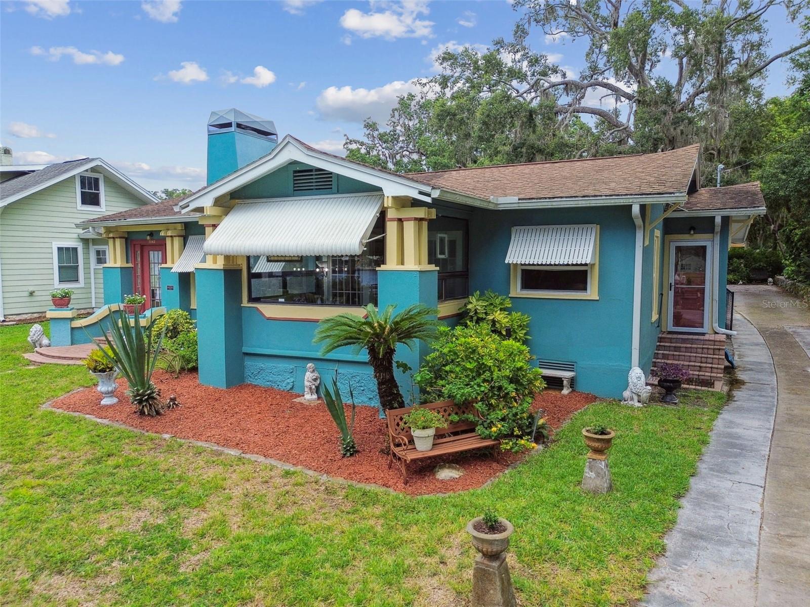 Own a piece of New Port Richey history with this one-of-a-kind waterfront property on Grand Boulevard. This charming 4 bedroom, 3 bath home includes a legal detached in-law suite, a private dock with boat lift, a sparkling pool, and one of the largest lots in the downtown district, offering a rare combination of character, functionality, and location. Originally a Sears & Roebuck Osborn model, this historic residence features beautifully preserved details including original hardwood floors, wide baseboards, vintage glass windows, and a show stopping stone fireplace. The main home offers a spacious layout with a large dining room, a sun-drenched enclosed porch with river views, and a fully updated kitchen with granite countertops and modern appliances. The primary suite boasts private pool access, an ensuite bath, and interior laundry, while the additional bedrooms feature tall ceilings and abundant natural light. Out back, you’ll find a true Florida oasis, lush landscaping, a screened in pool area, a private courtyard, and beautiful oak trees that offer shade and tranquility. The detached in-law suite includes a full kitchen, living area, bedroom, and bath, making it perfect for extended family or rental income. A recently constructed oversized 2 car garage with workshop and storage loft, additional off street parking, and gated driveway complete the property. Enjoy direct access to the Cotee River, walkability to downtown shops and restaurants, and a front-row seat to the charm and beauty of historic New Port Richey. New Port Richey is a golf cart community allowing easy access to the historic downtown. This is a rare opportunity to own a riverfront estate with endless possibilities. (ROOF-2012)(A/C-2013)(W/H-2013)