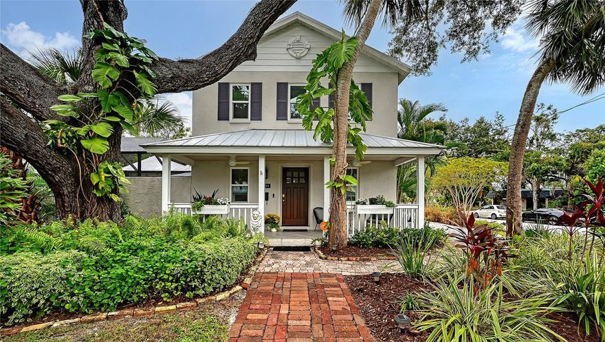 Perfectly situated in Sarasota’s vibrant Downtown within the coveted Gillespie Park neighborhood, this exquisitely renovated two-story Key West–inspired residence blends timeless architectural charm with modern sophistication. A magnificent oak tree graces the front yard, framing the home’s welcoming façade, while a historic brick driveway—crafted from original Sarasota street bricks—sets the stage for the artistry and attention to detail found throughout. Inside, solid wood floors, designer lighting, and refined finishes create a warm yet elegant ambiance. The gourmet kitchen impresses with custom cabinetry with soft-close drawers, quartz countertops, and top-tier appliances including a professional Forno gas range, seamlessly marrying function and style. Open-concept living and dining spaces are enhanced by an electric fireplace and abundant natural light streaming through windows and doors, many of which are impact-rated. Upstairs, rich hardwood flooring continues through the private quarters, including the serene primary suite featuring a custom-built walk-in closet and a spa-inspired bath adorned with porcelain tile, designer fixtures, and a soothing neutral palette. The flexible floor plan offers versatility for today’s lifestyles: a downstairs bonus area—currently used as a Pilates studio with private entry—is zoned for business or rental use and could easily serve as a family room, media room, primary/guest bedroom or fitness space. A beautifully appointed 600-square-foot apartment offers full independent living, complete with a contemporary kitchen, induction cooktop, full-size washer and dryer, and a spacious private balcony—ideal for guests, extended family, or short-term rental income (one-week minimum rental permitted). Additional highlights include a temperature-controlled wine room, an oversized laundry area with attic storage, three zoned HVAC, and a security system. Outside, a lush courtyard with screened lanai and heated pool creates a tranquil retreat for relaxing or entertaining amid tropical landscaping. Set on a spacious, fenced corner lot, the property offers abundant privacy along with an expanded 2½-car garage featuring an impact-rated door and generous storage. Residents of Gillespie Park enjoy one of downtown Sarasota’s most walkable locations—just moments from fine dining, boutique shopping, arts and cultural venues, SRQ International airport, and the scenic Bayfront. The neighborhood’s namesake park offers tennis and pickleball courts, dog areas, and a lively community spirit that captures the essence of urban Sarasota living. Blending the character of Sarasota’s historic past with the ease of modern luxury, this exceptional residence delivers rare flexibility, craftsmanship, and an enviable location in the heart of it all.