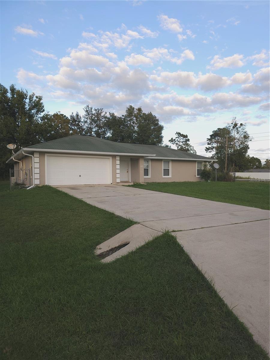 Beautiful Corner Home in Silver Springs Shores.  This inviting corner-lot home in the desirable Silver Springs Shores community of Ocala is ready for a new family to make it their own. Sitting on an oversized lot, the property offers ample outdoor space and convenient access to shopping, parks, and local amenities. Inside, you’ll find a bright, open floor plan with vaulted ceilings and plenty of natural light. The home is completely tiled throughout, featuring a split-bedroom layout for added privacy. Each bedroom is generously sized, and one of the guest rooms has direct access to the patio, perfect for relaxing or entertaining. The spacious living and dining areas make this home ideal for family gatherings. Schools nearby are well-known and highly sought after, adding to the appeal of this comfortable Ocala residence.