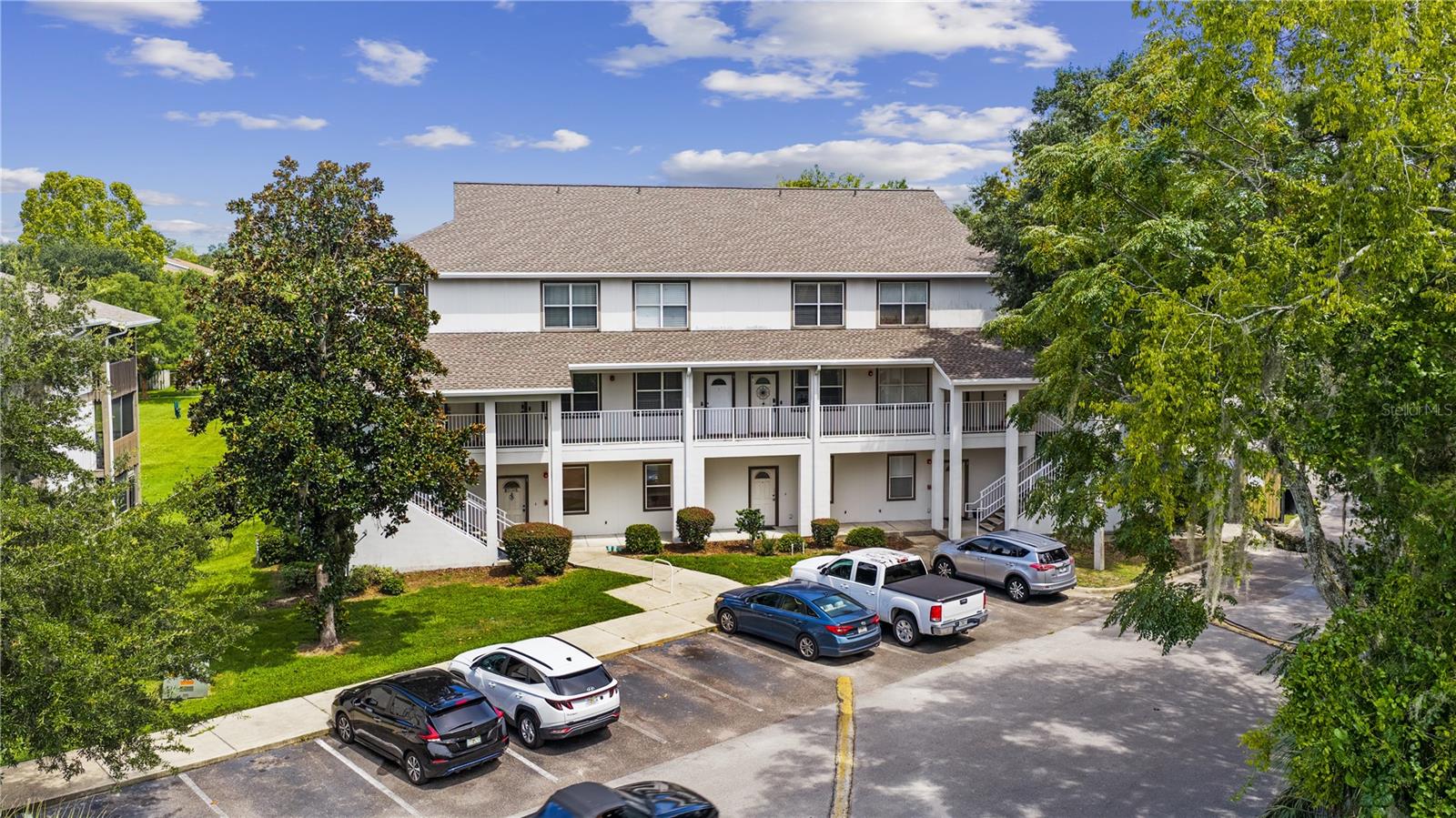 Just in time for gator season, this short-term rental has been professionally decorated & is fully stocked with supplies, turnkey and ready to host tomorrow. This building was built in 2008, & features 2 bedrooms both with en-suite full bathrooms upstairs, granite counters, tall & vaulted ceilings and lots of natural light. The fridge was replaced this year & HVAC in 2019. The location is ideal, right off of I-75, across from a major hospital, walking distance to shopping & restaurants & a short drive to the University of Florida. With a 5-year track record of 5-star reviews, the property is a proven investment. The association provides water, sewer & trash, as well as exterior maintenance. Everything has been done for you, come see this amazing opportunity today!
