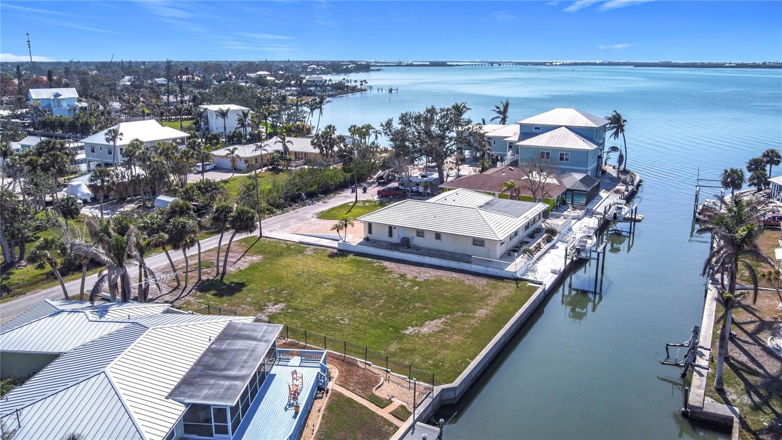 Build your Florida Dream Home on this Sailboat Concrete Sea-walled lot with No Fixed Bridges to Lemon Bay and the Intercoastal Waterway. Direct access to the Gulf of Mexico through Stump Pass. There is new elevated concrete seawall which was installed in 2019. Water and Sewer on the property. Lot is located in an AE Flood Zone. There is a Lot Survey and an Archeological Survey available. Just an easy walk or bike ride to Historic Downtown Dearborn Street where you can enjoy year round dining, shopping and local entertainment. There is a neighborhood county park just around the corner providing boat ramps for launching your boats and a covered Pavilion for outdoor entertainment. Enjoy Beautiful Gulf Beaches and World Class Fishing in your own back yard. If you are looking for that Special Lot to Build your Dream Home, give this one a close look.