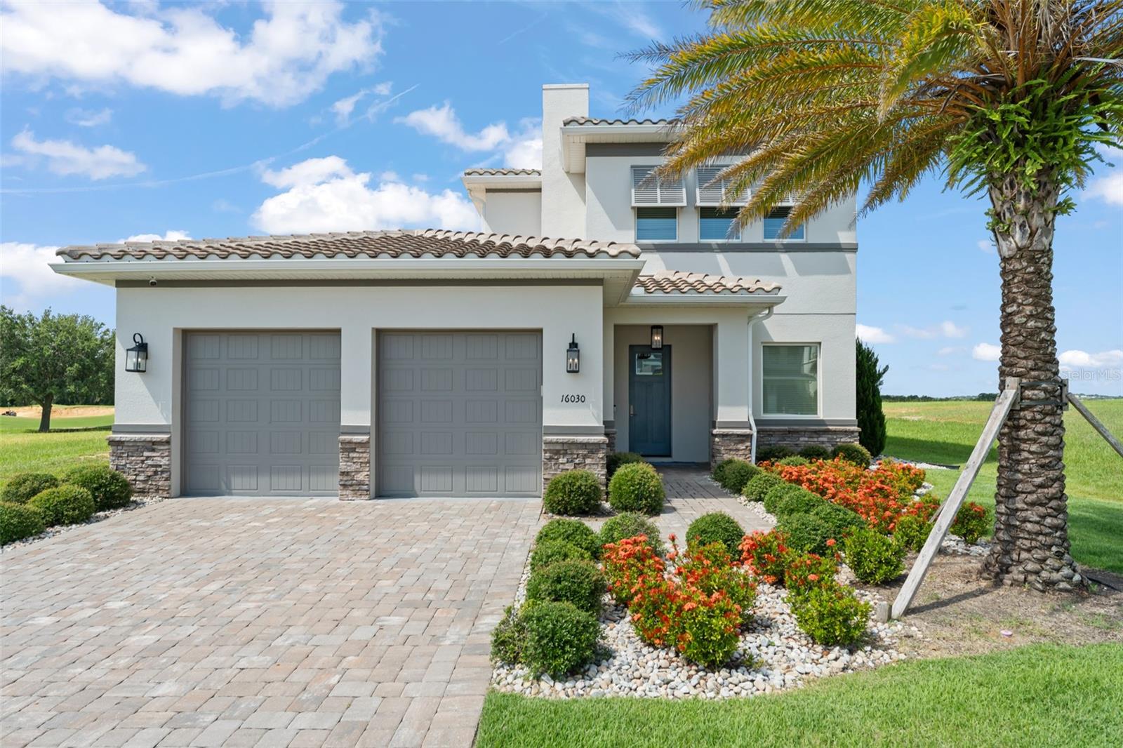 Nestled within the renowned gated community of Bella Collina, the Sorano is an exquisite 4-bedroom, 4½-bathroom residence that epitomizes luxury and serenity. This meticulously crafted home offers breathtaking panoramic views of the Nick Faldo-designed championship golf course and the picturesque rolling hills of Central Florida, creating an idyllic backdrop for refined living. Upon entering, you're greeted by a grand two-story foyer that seamlessly flows into the expansive open-concept family room and gourmet kitchen. The first-floor master suite is a private sanctuary, featuring two spacious walk-in closets and sliding glass doors that open to the pool deck. The spa-inspired en suite bathroom offers dual vanities, a luxurious soaking tub, and a separate glass-enclosed shower, providing a serene escape for homeowners. The airy design, accentuated by soaring ceilings and abundant natural light, creates an inviting atmosphere perfect for both relaxation and entertaining. The state-of-the-art kitchen boasts premium appliances, custom cabinetry, and a generous island, making it a chef’s delight and the heart of the home. Also on the main level, a versatile second en suite bedroom doubles as a great home office, ideal for remote work or guests. A well-appointed laundry room and a convenient two-car garage entrance enhance the home’s functionality. The garage opens directly into the foyer, ensuring effortless access. The Sorano’s outdoor living spaces are designed for year-round enjoyment. A remote-controlled screened lanai encloses a resort-style pool deck and a fully equipped outdoor kitchen, ideal for hosting unforgettable gatherings with family and friends. The covered patio, accessible from the master suite, provides a tranquil setting to soak in the stunning views. Ascend the elegant staircase to the second-story loft, a flexible space perfect for a media room, play area, or cozy lounge. Two additional en suite bedrooms give you comfort and privacy, with the rear bedroom featuring a private balcony overlooking the sparkling pool and lush golf course—a perfect spot to unwind. Located moments from The Club at Bella Collina, residents enjoy access to world-class amenities, including fine dining, a luxurious spa, tennis courts, and a fitness center. The gated community ensures privacy and security, offering an exclusive lifestyle in one of Central Florida’s most sought-after enclaves. The Sorano at Bella Collina combines meticulous design, modern conveniences, and an unrivaled location, making it the epitome of private community living. Don’t miss the opportunity to own this exceptional golf course home.