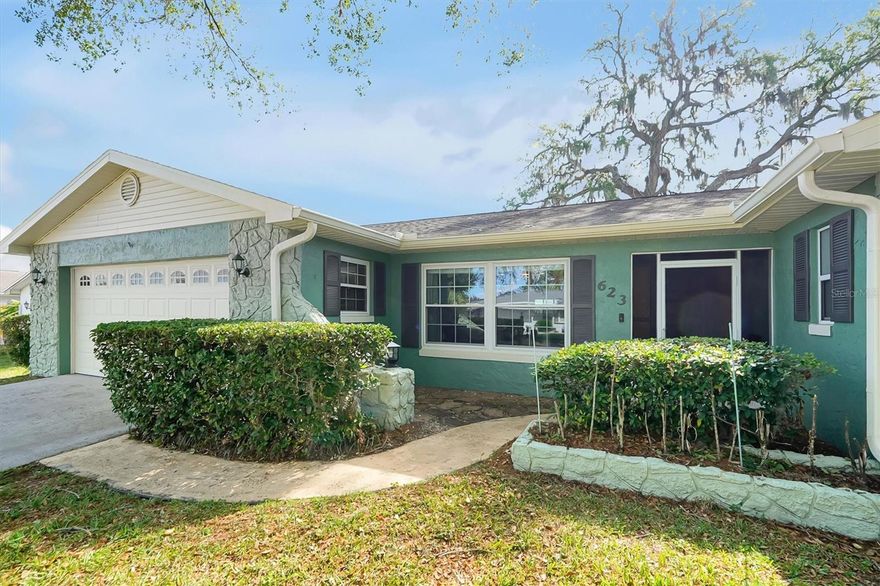 Experience classic Florida tranquility in this beautifully renovated 4-bedroom, 2-bathroom home. Tucked away under a canopy of majestic, moss-draped oaks, this residence offers a versatile floor plan and an expansive backyard designed for both relaxation and entertainment.

Step inside to find a seamless open-concept layout featuring durable wood-look laminate flooring and a fresh, neutral palette. The Kitchen is fully modernized with rich espresso cabinetry, striking granite countertops, and premium stainless steel appliances. The custom mosaic tile backsplash and central island with breakfast bar seating create a functional and stylish hub for the home.

With four true bedrooms, this home offers incredible flexibility. Whether you need a flex space, a guest suite, or a high-end home office, there is a dedicated space for every need. The primary suite standouts a dedicated dressing area and an ensuite bath featuring elegant stone-topped vanities. The guest bedrooms are spacious and bright, with one offering direct sliding door access to the sunroom—perfect for a private guest entrance or a morning exercise space.

The living space extends outdoors through a nicely sized screened patio. Perfect for a bug-free evening lounge. Step out further to the fully fenced backyard, where you’ll find an expansive green lawn anchored by an open-air stone patio ideal for summer BBQs and outdoor dining.

Additional highlights include a secure perimeter for pets and play, plus a large shed for additional storage and a 2-car garage with a dedicated laundry zone.