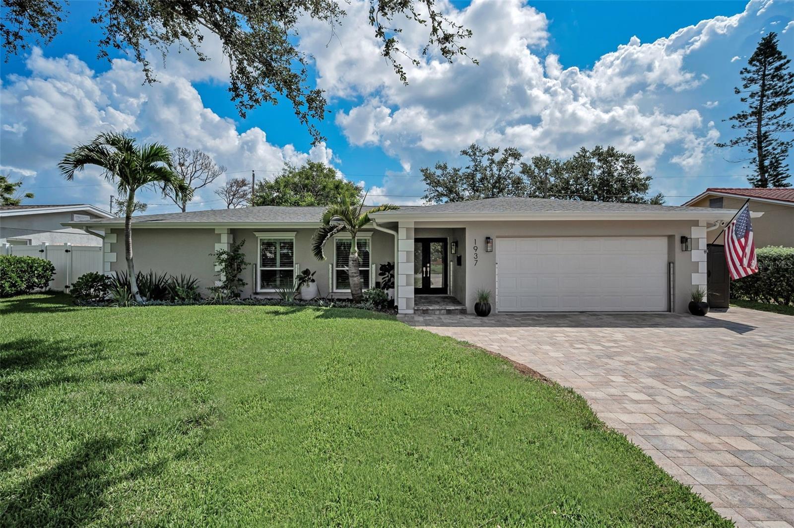 Timeless design, modern upgrades, and the best of Florida living converge in this coastal retreat, thoughtfully reimagined with elevated finishes and refined style. A freshly landscaped yard and paver driveway lead to the inviting front patio entry, setting the tone for what’s inside. The formal living room greets you with abundant natural light streaming through large windows, while porcelain plank tile flooring flows seamlessly throughout the home. At the heart of the residence, the expansive kitchen impresses with custom wood cabinetry reaching to the ceiling, quartz countertops that transition up the backsplash, and brand-new stainless steel appliances. Designed for both everyday living and entertaining, the kitchen opens to a spacious family room and dining area large enough for a full-length gathering table. The primary suite is a private retreat featuring a cozy, well-proportioned bedroom and a spa-like bathroom with custom tilework, luxe vanity, and champagne bronze fixtures that carry a timeless touch throughout the home. The split-bedroom layout offers generous guest rooms, and the guest bath, with its tub/shower combo, doubles as a convenient pool bath. Additional upgrades include plantation shutters on all windows, modern baseboards, two-panel doors with updated hardware, and a well-appointed indoor laundry room with extra storage. Step outside to your personal oasis: a 2016 Pebble Tec salt water pool with a fountain feature and sun shelf, surrounded by travertine pavers, new fence and complemented by a grassy area perfect for outdoor play. The exterior of the home’s thoughtful enhancements includes updated windows, new pool equipment, landscape lighting, Garrison Hammer Head flood plank system, RV hookup, sewer back flow valve and wrapped interior sewer lines. Ideally located in unincorporated St. Petersburg, this property blends modern coastal style with convenience, offering quick access to parks, shopping, dining, and major highways while giving you the lifestyle you’ve been dreaming of.