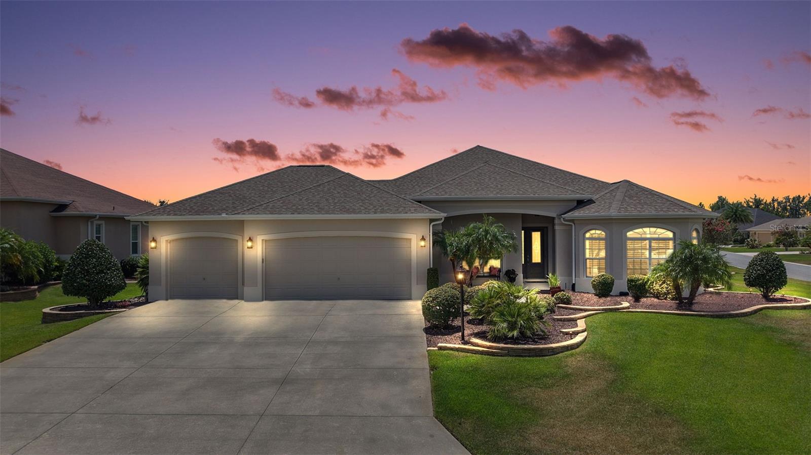 Experience PREMIER LIVING at its best in this EXQUISITE, ONE OWNER, 3/2 Natchez boasting an OVERSIZED (998 sq ft) full 3-CAR GARAGE, and an EXPANSIVE 30’ x 18’ enclosed lanai, situated on a .30 acre CORNER LOT with ROOM FOR A POOL and/or outdoor living addition, in an enclave all-PREMIER neighborhood of the village of Charlotte! BOND PAID! Enjoy the financial benefit of a BOND-FREE HOME – a $32,300 value PAID OFF early by the current owner! A FRESHLY PAINTED exterior, TROPICAL landscaping with CURVED walls, and QUAINT front porch welcome you in to this METICULOUSLY-MAINTAINED home. Step inside the beautiful LEADED-GLASS entry door with sidelight and retractable screen into the GENEROUS foyer. Setting a tone of PURE ELEGANCE throughout the ENTIRE home are 10' ceilings, 8' doorways, 5¼” baseboards, and PLANTATION SHUTTERS. The VOLUMINOUS, OPEN CONCEPT living and dining rooms showcase DIAGONAL TILED floors. ELEGANT columns add to the grandeur of the formal dining room while a 12' TRAY ceiling adorns the living room. From these rooms, a DOUBLE set of POCKET sliding glass doors, invite you in to the EXPANSIVE 30’ x 18’ ENCLOSED LANAI featuring 10' ceilings, FULL LENGTH sliding glass door panels, and solar shades. This FABULOUS ROOM offers 540sf of ADDITIONAL LIVING SPACE to this AMAZING home! The adjacent REAR PATIO with PRIVACY landscaping is ideal for grilling or simply enjoying the beautiful Florida weather! Back inside, the STUNNING kitchen features RICH WOOD cabinetry, GRANITE countertops, center ISLAND, STAINLESS appliances, WALL oven, BUILT-IN pantry, EAT-IN breakfast bar, and an ADJACENT DINETTE with DOUBLE arched windows for an ABUNDANCE of natural light. The LUXURIOUS primary bedroom features a 12' TRAY ceiling, LVP flooring, and TWO CUSTOM WALK-IN closets. It’s en suite bathroom boasts TILED ROMAN STYLE WALK-IN shower, SOAKING TUB, RICH WOOD cabinetry with DOUBLE sinks and GRANITE counters, LINEN closet, and separate water closet. Near the front of the home, a POCKET DOOR separates two remaining bedrooms and additional bath by creating a PRIVATE guest wing and/or QUIET home office area. Bedroom two boasts a BAY window, HIGH ceiling, LVP floor, and a CUSTOM built-in closet. The second bathroom features a RICH WOOD vanity with GRANITE top, TILED tub and shower combination, and hall LINEN closet. Bedrooms three offers HIGH ceiling, LVP flooring and CUSTOM built-in closet. A centrally located interior laundry room features additional RICH WOOD cabinetry, TILE floors, shelving, and utility sink. Completing the package is the OVERSIZED (998 sq ft) full 3-CAR GARAGE, EPOXIED floors, ABUNDANT storage cabinets, and attic access stairs. ADDITIONAL UPGRADES include an alarm system and whole-house water softener. DON"T MISS the OPPORTUNITY to make this MAGNIFICENT HOME YOUR OWN! The Village of Charlotte is conveniently located between Brownwood Paddock Square and Lake Sumter Landing; Belle Glade, Bonifay, Havana, and Evans Prairie Championship Golf Courses and Country Clubs; Colony Cottage and Rohan Regional Recreation Centers; Charlotte Neighborhood Pool and Recreation Center; Sarasota Golf Academy and Practice Center; Sharon Rose Wiechens Preserve; Atlas Dog Park; Colony Shopping Plaza; and 466A with an abundance of shopping, restaurants, banks, medical, and more! PLEASE WATCH OUR WALKTHROUGH VIDEO of this EXCEPTIONAL HOME IN A FABULOUS LOCATION and call today to schedule your Private Showing or Virtual Tour!