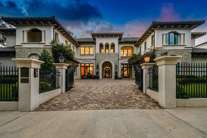 Nestled within prestigious Beach Park, this gated Mediterranean custom estate offers a refined and luxurious living experience. Situated on a meticulously landscaped .3-acre property, this architectural gem boasts 5 bedrooms and 5.5 baths. The curved staircase graces the foyer, creating a grand entrance that sets the tone for the elegance that awaits. Anchoring the living space is the great room, a sanctuary defined by its soaring 26-foot ceilings adorned with a magnificent smoky quartz crystal chandelier. The formal dining room is an ode to elegance, featuring twin crystal chandeliers that illuminate a contemporary wine wall, artfully displaying up to 700 bottles of vintage selections. A haven for those who love to entertain, the full wet bar was designed to fulfill every host's dream, with beverage drawers & wine fridge. For those who cherish the outdoor Florida lifestyle, a captivating pool, sunken hot tub, and an outdoor kitchen and cabana provide an oasis of leisure. A wood-burning fireplace and inviting lanai set the stage for al fresco gatherings, while lounging areas invite you to unwind amidst mature tropical landscaping. The gourmet chef's kitchen, where culinary mastery meets sophisticated design. Encompassing two Wolf refrigerators, Wolf gas ranges with custom stainless and enamel hood, dual sinks, and built-in espresso bar, microwave and air fryer. The breakfast room, featuring ample seating for up to 15 guests, provides an ideal setting for indulgent gatherings. The heart of the living space is a captivating three-sided floor-to-ceiling marble gas fireplace, a true masterpiece of craftsmanship and ambiance. Ascend the staircase to a world of serenity, where the sleek master suite awaits. A marble gas fireplace creates a tranquil ambiance, while the ensuite boasts a Japanese spa-style steam shower and soaking tub, offering a private sanctuary for relaxation. Her closet, adorned with window seats and twin islands, is a testament to luxury and organization. An elevator ensures effortless movement throughout the home, while the four-car double garages offer ample space for automotive enthusiasts. Additional living quarters include the theater room, office, and a dedicated playroom and workout space. A private-access Mother-in-Law suite is accessible from the second floor via elevator or from the 2nd floor. Every corner of this estate is bathed in the glow of designer lighting and plumbing fixtures, while European wall coverings lend an air of refined opulence. Rich wood flooring flows seamlessly throughout, complemented by oversized Carrera marble tiles that showcase meticulous attention to detail. This home is equipped with the latest in Control 4 technology and a state-of-the-art security system, ensuring comfort and peace of mind. Additionally, three sets of washers, dryers, and dishwashers streamline daily tasks. Immerse yourself in a world of refinement, where Bevolo gas lanterns cast a warm glow upon the exterior and the landscape reveals a tapestry of mature tropical beauty.