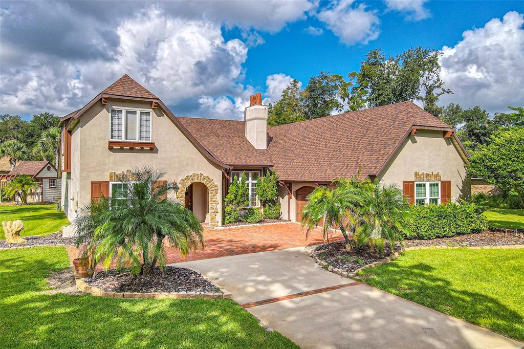 This stunning two-story Tudor home has an abundance of gorgeous features including a new roof with clay pot chimney tops, brick pavers leading to your side load garage with Chalet doors. Gourmet kitchen with gas stove, stainless appliances, bartop seating, and arched openings to the living room, the home has abundant space with a large studio great for a hobby room, billiards, or your dream setup. Not only is there a large studio room but the rear enclosed Florida with beautiful tongue and groove ceilings is spacious and sets up well for entertaining and dining in the near outdoors. Master bedroom has tandem Nursery or office. This home is stunning inside and out exterior features a shed with columns and brick pavers. Possible 4th bedroom. This gorgeous home has many features to list, schedule your showing today, this gem won't last!