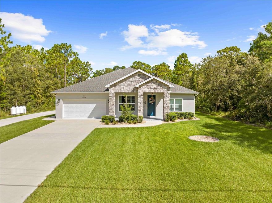 Welcome to Pine Club Circle…a stunning 4-bedroom, 3-bathroom with a den and a 2-car garage that offers 2,446 square feet of living space on nearly a ½-acre lot, combining luxury, energy efficiency, and exceptional functionality. Built using Insulated Concrete Forms (ICF), the home features solid poured 6 inch concrete pured walls that provide superior structural integrity along with R28 insulation on the walls and R30 in the attic—helping keep utility costs impressively low. Beyond its outstanding construction, the home is equipped with a hardwired security system, myQ-controlled garage door openers, and a large whole-home generator with multiple propane tanks, ensuring you're prepared and powered through any situation. Also INCLUDED is a 40x40 detached metal garage with its own concrete driveway, fully insulated with spray foam and wired for electricity, offering the ideal space for a workshop, extra storage, or additional vehicle housing. From the moment you arrive, the custom stone façade and impressive curb appeal set the tone for the high-quality finishes and thoughtful design found throughout.
Inside, you’re welcomed by an expansive open floor plan with high ceilings and luxury vinyl plank (LVP) flooring throughout. Just off the entry is a formal sitting room or den, offering flexible space for a home office, library, or quiet retreat. The open-concept main living area connects seamlessly with the dining room and kitchen, creating the perfect setting for entertaining or everyday living. The kitchen features Cambria Quartz countertops, an oversized center island, an under-mount sink, 42-inch real wood soft-close cabinetry with a built-in spice rack, a dedicated coffee bar, and two large pantries for ample storage. It also includes a new range, vented microwave, dishwasher, and flush-mount LED lighting. Just behind the kitchen, a spacious laundry room offers a functional workspace with a deep sink and an additional storage closet.
The split-bedroom floor plan ensures privacy in the luxurious master suite, which boasts two large walk-in closets, high ceilings, and a spa-inspired en-suite bathroom. This serene retreat features dual under-mount sinks set in Quartz countertops, real wood soft-close cabinetry, a garden tub, a walk-in subway tile shower, and a private water closet. The guest bedrooms are located on the opposite side of the home, each generously sized with LVP flooring, large closets, and flush-mount LED lighting. One of the guest bedrooms features a private bath with direct access to the lanai, making it an ideal space for overnight guests or multigenerational living. The remaining full bathrooms feature Quartz counters, ceramic tubs, and elegant subway tile finishes.
A triple sliding glass door in the main living area opens to the covered, fully screened lanai, providing the perfect space to enjoy Florida’s beautiful evenings. Unlike many homes, this one includes an insulated attic above the garage—allowing you to fully insulate the garage by simply insulating the door. Additional premium features include nickel door hardware, 6-inch flat stock baseboards, 10-inch solid surface window sills, and an insulated solid-core front door. The home also comes equipped with a 40-gallon water heater, a high-efficiency HVAC system with a programmable thermostat, and comprehensive pest control with the Taexx in-wall system and Bora-Care termite prevention treatment. Schedule your appointment today and make this home yours!