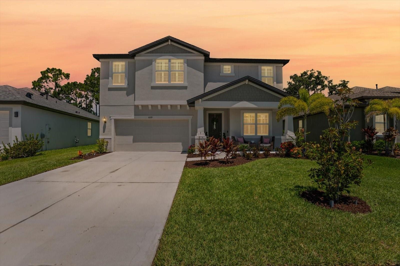Welcome to your perfect Florida retreat, located in an active golf course community and just a short drive to world-renowned beaches like Anna Maria Island, Longboat Key, and St. Pete Beach. This stunning two-story home built in 2023 offers the ideal blend of luxury, comfort, and convenience. From the moment you arrive, you'll be charmed by the inviting covered front porch and spacious two-car garage. Inside, this home looks like a model home and boasts elevated ceilings and tile flooring throughout the main living areas, creating a light and airy atmosphere. At the front of the home, a flexible living space showcases a floor-to-ceiling shiplap electric fireplace, perfect as a formal sitting room, stylish home office, or creative studio. The heart of the home is a beautifully designed great room, complete with a tray ceiling, built-in surround sound, and sliding glass doors that open to a private outdoor oasis. The eat-in kitchen is a dream for home chefs and entertainers alike, featuring a large quartz island, double wall ovens, and ample cabinetry. The main-level primary suite is a peaceful retreat with a dual-sink vanity, luxurious marble-style tiled shower, and private water closet. Upstairs, a generous flex loft area offers endless possibilities—think playroom, media room, or second family room—alongside a private en-suite bedroom, two additional guest bedrooms, and another full bath. Step outside to enjoy the covered back patio, equipped with two ceiling fans, a TV mount, and tranquil tree-lined views—ideal for relaxing after a round of golf or a sunny beach day. Situated on a beautiful Preserve and ample space to add a pool. This home’s versatile floor plan, modern finishes, and unbeatable location make it perfect for full-time living, entertaining, or enjoying a vacation lifestyle year-round. If you golf, it's right here in your community, fees are not included or required when living here. Best of all, there are NO CDD fees and a LOW HOA! Conveniently located near Publix grocery store and the Gateway Commons shopping center, you'll have everything you need right at your fingertips. The home is also close to various dining options, parks, and recreational activities. Explore the nearby Ellenton Premium Outlets for a shopping spree, or enjoy the scenic beauty of Terra Ceia Preserve State Park. For commuters, Imperial Lakes at the Fairways provides easy access to major roadways, making it a breeze to reach Tampa, St. Petersburg, and Sarasota. Don't miss your opportunity to live the Florida lifestyle in a like-new home with all the upgrades and none of the wait.