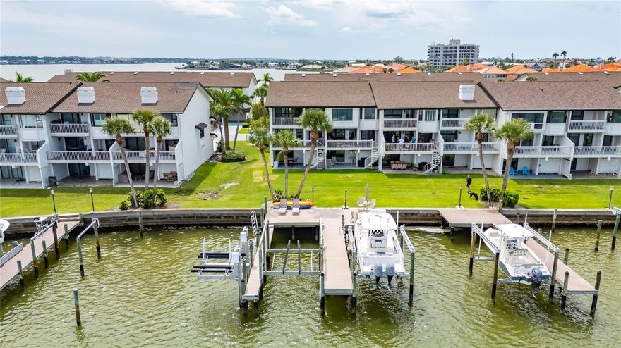 BRING YOUR BOAT AND YOUR LOVE FOR COASTAL LUXURY! This FULLY FURNISHED end-unit waterfront townhome in the sought-after Marina Del Rey community on Sand Key offers the ultimate Florida lifestyle with breathtaking open water views and direct boating access. Completely renovated with elegant coastal finishes, this spacious home spans three levels of versatile living space. First Floor: A flexible bonus room (ideal as a boat room, game room, or guest retreat) features a wet bar, full ensuite bath, and sliding doors to a private patio with backyard and dock access. Second Floor: Drenched in natural light, the main living level boasts a designer kitchen with white shaker cabinetry, waterfall-edge island, gleaming countertops, and top-of-the-line stainless appliances. A home office/bonus space (potential 4th bedroom) and a stylish half bath are nearby. The open dining and family rooms are wrapped in windows showcasing stunning views of the Intracoastal and marina. Third Floor: The luxe primary suite offers a private waterfront balcony, a massive walk-in closet with custom built-ins, and a spa-style ensuite bath featuring double vanities and a dramatic wet room with soaker tub and shower — all with water views. A second light-filled bedroom includes a large closet and updated ensuite with a walk-in shower. Additional highlights: Plantation shutters throughout, Spacious laundry room, Abundant storage. Boaters will fall in love with the double dock with sundeck, 20,000 lb boat lift, 2 jet ski lifts, kayak lift, and TREX decking with dual-side boat access — all right in your backyard! All of this just across the street from the beach, near Sand Key Park, and a short walk to restaurants and boutiques. This is coastal living at its finest — don’t miss your chance to lease a slice of Sand Key paradise!