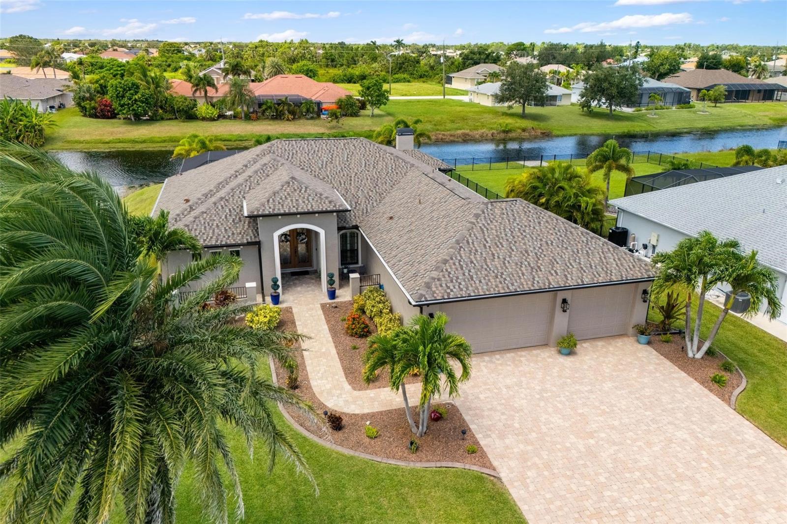 Stunning Rotonda West Waterfront Home – Resort-Style Pool & Luxury Upgrades!
Experience the ultimate Florida lifestyle in this 3-bedroom, 2.5-bath luxury waterfront home set on an oversized lot with water on two sides, offering both privacy and sweeping canal views. From its oversized 3-car insulated garage to the resort-style pool and patio, every detail has been designed for comfort, elegance, and peace of mind.
Inside, you’ll find soaring 11-foot ceilings, crown molding, a curved foyer ceiling, and tile flooring throughout. The open-concept great room flows seamlessly into the chef’s kitchen, complete with a large island, dry bar, GE Café stainless steel appliances, a dual-fuel propane range, 42-inch wood cabinetry, granite countertops, and both under and over cabinet lighting. This home is ideal for both entertaining and everyday living.
The master suite offers a true spa-like retreat with his-and-hers walk-in closets featuring custom cabinetry, dual vanities with a dedicated makeup area, a free-standing tub with waterfall faucet, and a Roman shower. A split-bedroom floor plan ensures guest privacy, while upgraded finishes including a designer front door, tray ceilings, and elegant details are found throughout the home.
Step outdoors to your private oasis, where the oversized screened patio and pool area invite you to relax in style. Enjoy a cocktail at the in-pool table, listen to the soothing copper waterfall features, or gather with friends around the outdoor gas fireplace. The upgraded pool finish, outdoor TV, irrigation system off the canal, and professional landscaping with St. Augustine grass and curbed borders all contribute to effortless Florida living.
Recent updates provide peace of mind, including a new roof with fascia, soffits, and guttering completed in 2024, two new A/C systems with whole-house air purifiers installed in 2025, and all pool screens replaced in 2024. Impact glass windows and doors, a whole-house water filtration system, and an epoxy-finished oversized 3-car garage with built-in storage closets complete the package.
Beyond your doorstep, Rotonda West offers the best of Southwest Florida. You’ll enjoy easy access to five neighborhood golf courses, world-famous Boca Grande and Englewood beaches, boating and fishing in Charlotte Harbor and the Gulf of America, and a variety of waterfront dining, shopping, and entertainment options. Whether you’re teeing off, strolling along sandy shores, or enjoying spectacular sunsets, this community is designed for an active, resort-inspired lifestyle.
With furnishings available for purchase, this residence combines luxury, convenience, and a true resort-style atmosphere. Whether you’re cooking in the gourmet kitchen, relaxing poolside, or watching serene water views from your backyard, every detail of this home has been thoughtfully designed to showcase the best of Rotonda West waterfront living. Peace of mind bonus: this home is located outside of a flood zone — no flood insurance required!