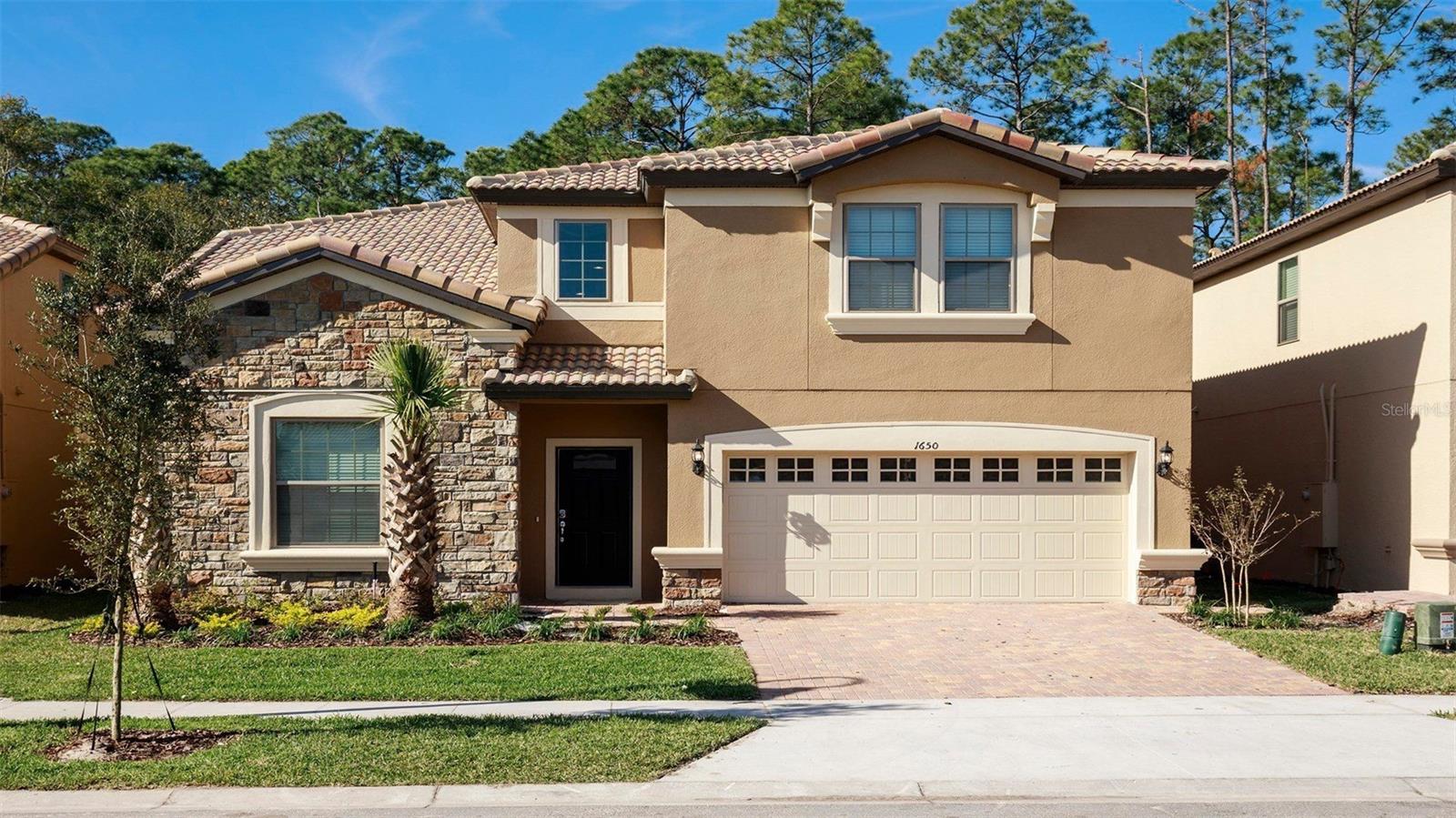 Fully furnished and move-in ready, this expansive 9BR/6BA pool home delivers long-term luxury living just minutes from Disney. The open great room flows to a state-of-the-art kitchen (breakfast bar) and an elegant 12-seat dining area. Main level includes two en-suite bedrooms; upstairs offers a spacious loft/second living room plus seven additional bedrooms (several tastefully themed) and multiple full baths. Enjoy Smart TVs, high-speed internet readiness, in-home laundry, and ample driveway parking. Outside, relax on the covered patio and your private screened pool & spa—perfect for everyday Florida living. Resort-style community amenities include a clubhouse, resort pool, lazy river/splash area, tiki bar, fitness center, sports courts, arcade, and a sundry shop (amenities operated by the HOA; availability subject to their schedules). Prime location near I-4/US-192, shopping, dining, and entertainment.