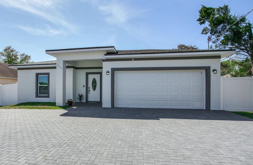 Beautiful Newer 3/2 home in Dunedin! Rock solid concrete block exterior with stucco finish and built with superior rigid foam-cell insulation for excellent insulation performance, moisture resistance, and energy efficiency. The windows and exterior doors are impact resistant (hurricane rated). brilliantly distributed floor plan! It is ideal for a small or medium family. Featuring high ceilings at 8'8", gorgeous arched crown molding, kitchen with an island which serves as a breakfast bar, large family/dining room area, and very spacious bedrooms. The rear door leads to the covered backyard lanai, which is finished with pavers and includes a spa. The large master suite has 2 "his and hers" walk-in closets and its master bathroom features dual sinks, modern tile, and a private water closet for the toilet which is a great plus! vinyl fence encloses the backyard, making it perfect for entertaining. The 2-car garage comes equipped with a door remote. The driveway has been expanded into a large 18' x 50' parking pad to make turning around a breeze!