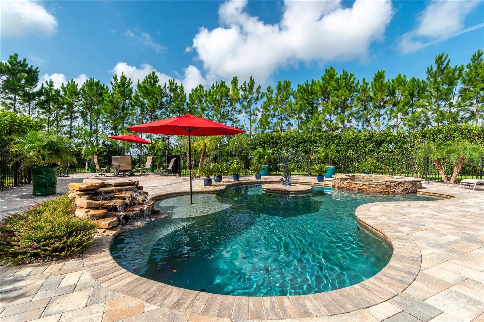 Absolutely stunning pool home in the beautiful 55+ golf community of Stone Creek. From the moment you drive up to this home the curb appeal makes this property stand out from the rest! Sitting on one of the largest lots in the community, the backyard oasis provides privacy as you relax in your own whirlpool spa. A custom glass door & stone paved driveway welcomes you home. High ceilings, crown molding, custom window treatments, and cherry wood floors make this home truly special. The home features a gourmet kitchen with all the bells & whistles, a huge granite island, gas cooktop, wine fridge, stainless steal appliances, soft close cabinets & a huge walk in pantry. With 10 foot ceilings and 8 foot doors, the living/family room overlooks your backyard oasis with triple retracting glass sliders leading to the patio/pool deck where the resort style pool, spa and fire pit beckon you to vacation in your own home. The primary suite includes French doors leading to the relaxing hot tub, a fantastic ensuite and custom walk-in closet. The upstairs loft includes a large family/game room, a second master suite large enough to accommodate a kingsized set with a full bath and large walk-in closet space. This home has so many luxurious upgrades just cannot list them all. This one is a must see. Call for you showing today.