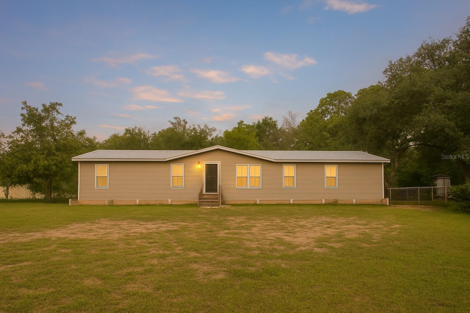 Welcome to this beautifully updated double-wide manufactured home sitting on a ½ acre of high and dry, fully fenced land in Eustis, Florida! Offering the perfect mix of modern upgrades and country charm, this property is ideal for those looking for space, comfort, and room for animals.
Inside, you’ll find 2,128 square feet of living space featuring 4 spacious bedrooms and 2 full baths. The oversized primary suite is a true retreat with a massive walk-in closet and an additional flex space, perfect for a home office, nursery, or private sitting area.
The home was completely updated in 2021 with top-quality improvements, including a 50-year metal roof, brand new well, updated septic system, and all-new interior finishes—giving you peace of mind for years to come.
Step outside and enjoy the freedom of country living. The property is fully fenced, making it perfect for goats, chickens, horses, or any animals you’d love to bring along. A barn in the backyard is ready for use, offering endless possibilities for storage, hobbies, or livestock.
Whether you’re looking for a homestead, a family retreat, or simply a home with plenty of space both inside and out, this Eustis property checks all the boxes!
