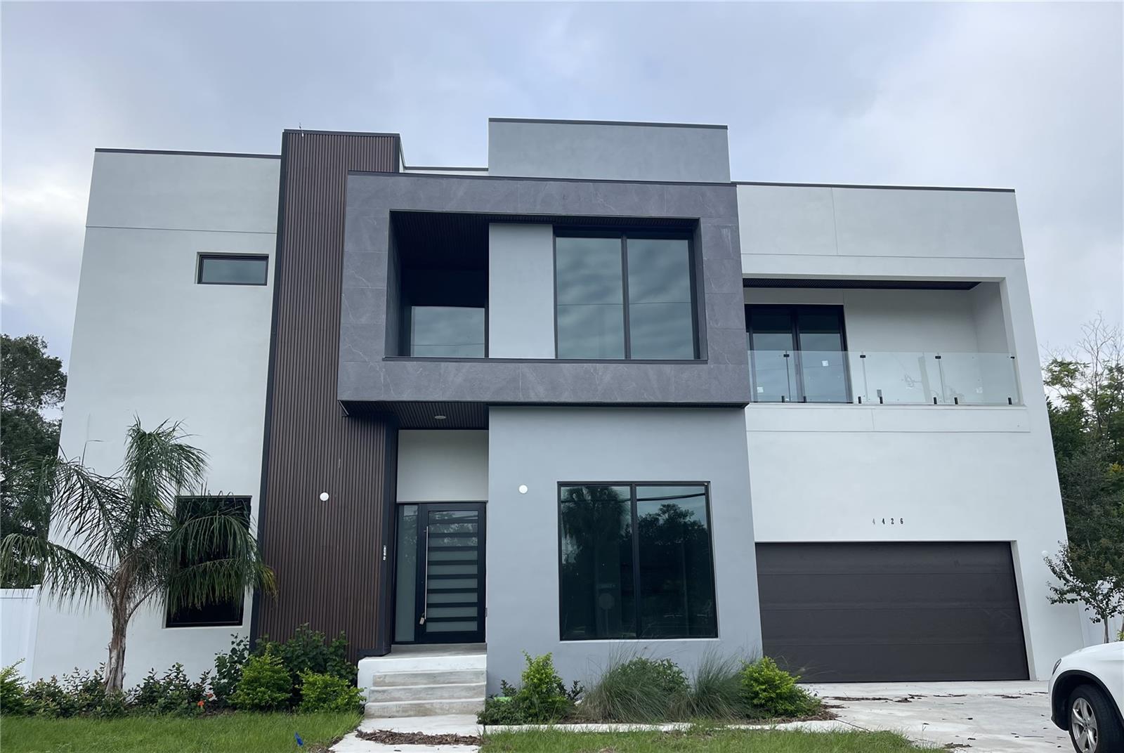 Under Construction. Under Construction – Almost Complete! Discover the perfect balance of modern elegance, thoughtful design, and HURRICANE RESISTANT construction in this stunning new South Tampa residence. With 4 spacious bedrooms, 4.5 bathrooms, and a 2-car garage, this home redefines luxury living while offering peace of mind and resilience for Florida’s climate.
From the moment you enter, soaring 11-foot ceilings create an atmosphere of openness and sophistication. The grand living area showcases a contemporary fireplace as its focal point, complemented by a striking wine display beneath the staircase. The open-concept design flows seamlessly into the dining and kitchen areas, ideal for both intimate family gatherings and large-scale entertaining.
The chef’s kitchen is nothing short of extraordinary—featuring sleek cabinetry that extends all the way to the ceiling, a waterfall island finished in quartz, high-end appliances, and abundant counter space. Every detail was designed with functionality and style in mind.
Every bedroom in this home is its own private retreat, complete with an en-suite bathroom and private balcony. A guest bedroom on the first floor offers comfort and convenience, while the upstairs living space features a stylish wet bar, and a theater room perfect for entertaining. The primary suite elevates everyday living with a spa-inspired bathroom, complete with a double-sink vanity, soaking tub, oversized walk-in shower, and a custom-designed walk-in closet that blends luxury with practicality.
Step outside to enjoy Florida living at its finest. The covered lanai and outdoor kitchen make al fresco dining a breeze, while the sparkling pool and beautifully illuminated fenced yard create the ultimate backdrop for relaxation and entertaining.
Set within one of South Tampa’s most coveted neighborhoods and top-rated school districts, this home offers not only an exceptional lifestyle but also the added confidence of hurricane-resistant construction and finishes. Every feature has been carefully curated to provide a home that is as strong as it is stunning.
Don’t miss the opportunity to make this modern South Tampa masterpiece your own. Schedule your private tour today and experience the next level of luxury living.
