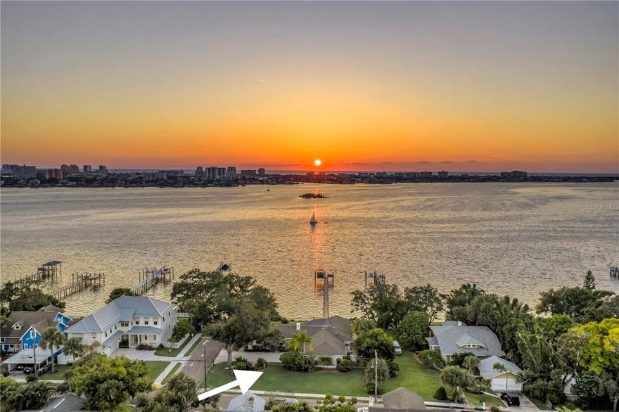 One or more photo(s) has been virtually staged. Tired of being right on top of your neighbors house? Searching for a home on elevated land but with NO STEPS to get inside the front door or anywhere else inside the house?  Sounds impossible to find… Until TODAY! EMBRACE COASTAL WATERFRONT LIVING TO ITS FULLEST with this well maintained, move-in-ready, open water view paradise with the most incredible sunsets. This property is surrounded by mature landscaping on an oversized,.39 acre lot with 100ft of water frontage. Properties along Sunset Dr. on the bluff DO NOT go up for sale often.  THIS HOME HAS NEVER FLOODED. It sustained NO DAMAGE from the 2024 storms.  In fact, the majority of the property and house are in a non-flood zone. This home is all block construction and mostly on a crawl space. The large lot size allows room for growth if desired.  The living space features a tiled fireplace, water views from every angle and new LVP floors. The kitchen is light and bright with a breakfast nook, granite counters, stainless appliances, soft close cabinets with several pull-out drawers to make the best use of space. It is conveniently accessible to the enormous covered lanai and to a utility/inside laundry room with a sink, floor to ceiling cabinets and pantry that provides an abundance of storage. There is also a natural gas line located directly behind the current electric oven if you prefer to switch to gas.  The primary suite addition was completed in 1993. The dimensions for the bedroom are 16x23 not including the large walk-in closet or bath.  This dreamy primary suite has stunning water views, a vaulted ceiling, access to the lanai and a large walk-in shower. The primary suite is accessed through the office, which includes built in shelving/desk, a closet and full bath. The possibilities for this space are endless and could make a fantastic mother-in-law suite! The second and third bedrooms are both good size and on opposite side of the house. The updated, main guest bath has access to the exterior pool deck.  The backyard oasis features a large, covered lanai with beautiful beams and a cathedral ceiling. The Pebble Tec surface, salt water pool has a built in spa that is heated with natural gas. Imagine the breeze off the open view of Clearwater Harbor. The long dock with rope railing and Trex decking feels like it came out of a story book. At the end, enjoy the large built in Trex bench for seating while watching the sunset. It’s an ideal spot for winding down at the end of the day to watch the sailboats, dolphins, manatees, seabirds and even fireworks during holidays. The dock was built in 2017 and includes a 9000 LB Hi Tide lift that provides easy access to the intercoastal waterway, Caladesi and Honeymoon Islands and the Gulf. OTHER: Transferable flood policy ONLY $1315 a year!  Roof(2012), 2 Trane AC systems-regularly maintained since owned (2014), garage doors, some windows and 2 sliders updated to impact resistant (2023), exterior paint and light fixtures (2025). This prime location has NO HOA and has easy access to the Pinellas trail, Coachman Park/Baycare Sound and more. It is set between the quaint town of Dunedin, Downtown Clearwater/ Clearwater Beach making this home just minutes from an array of restaurants, nightlife, shopping and beaches.  Call today to schedule a viewing and make everyday feel like a DREAM COME TRUE... AT HOME.