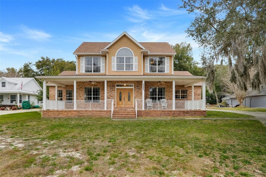 LAKEFRONT CUSTOM HOME ON LAKE LOUISA WITH 100 FT ON THE CLERMONT CHAIN OF LAKES. THE PROPERTY HAS A DOCK AND ELECTRIC BOAT HOIST. Beautiful screened 20X32 in ground pool. FULLY FURNISHED INCLUDES ALL KITCHEN ITEMS, LINENS, ECT. TRULY A TURN KEY HOME.  ONLY ONE OWNER!!!!  EXQUISITE SUNSETS.  PEACE AND TRANQUILITY.  As you walk in the beautiful front double doors with etched glass you will see archways throughout and the living room is very open and airy with two ceiling fans, real hard wood floors, crown molding and a pocket slider opening up to the covered, screened lanai over looking the pool. The breakfast nook is off to the right with a beautiful bay window. The kitchen has beautiful custom built cabinets with crown molding, an island, granite counter tops, crown molding around the ceiling, can lighting, pendant lighting, under the counter lighting and an advantium microwave. The formal dining room has a tray ceiling and windows facing the lake. The Master Suite has a ceiling fan, a huge walk-in closet, Tray ceiling and French doors that open to the lanai and pool. The Master Bath has a tiled walk in shower and a huge soaker tub and dual cultured marble sinks. The second bathroom is near the kitchen and has a door to the pool area, tiled shower and a cultured marble sink. The utility room is inside and has a washer and dryer. As you walk up the stairs there is a bonus room with a ceiling fan and has lots of windows, a niche and sitting area. Bedroom two has a ceiling fan, carpet and a walk-in closet. Bedroom three has a ceiling fan, carpet and a walk-in closet. Bathroom three is a tub shower combo, tile and a cultured marble sink. The front exterior has beautiful landscaping, huge 1/2 wrap around porch to watch the lake life and beautiful views of Lake Louisa. The house exterior is brick and Hardie Plank Siding. The two car garage is a side entry and has a garage door opener. THE ROOF is 2022, POOL PUMP IS AROUND 3 YEARS OLD AND A/C IS 7 YEARS OLD. This property is close to shopping, schools and major highways and attractions