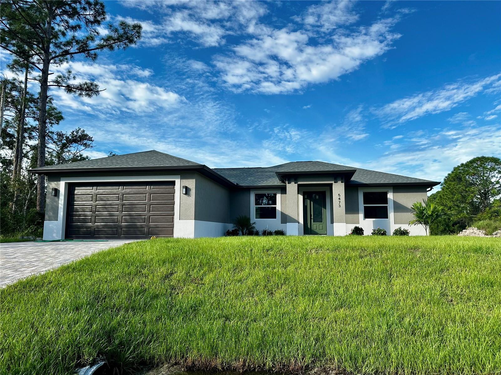Built in 2023, this thoughtfully designed home in North Port offers modern comfort, practical upgrades, and a peaceful setting just minutes from everyday conveniences. With three spacious bedrooms, a versatile den, and a flowing open-concept layout, this property is ideal for both relaxing and entertaining.
From the moment you arrive, you’ll notice the attention to detail—pavered driveway and walkway, hurricane-rated windows and doors, and an epoxy-finished garage floor for a clean, finished look. Inside, tile flooring runs throughout the home, adding both style and durability, while updated lighting enhances each room’s warmth and character.
The kitchen features quartz countertops, ample cabinetry, and seamless flow into the main living space. The primary suite is a true retreat with a generous en suite bathroom and a layout designed for privacy. The additional den offers flexibility as a home office, guest room, or creative space.
Step outside to the screened lanai with paver flooring, overlooking a private backyard with plenty of room to stretch out and enjoy. The property also includes an integrated irrigation system, helping to keep your lawn lush year-round.
Additional features include a brand-new water filtration system with reverse osmosis and UV light, a high-efficiency Samsung washer and dryer, and pest control services in place for added peace of mind.
Located just 5 minutes to I-75, 10 minutes to Cocoplum shopping and dining, and 20 minutes to Venice, the location blends quiet neighborhood living with easy access to everything you need.
Homes with this level of care and style don’t last long. Schedule your private showing today and see what makes 5473 Gagnon Terrace such a special place to call home.
