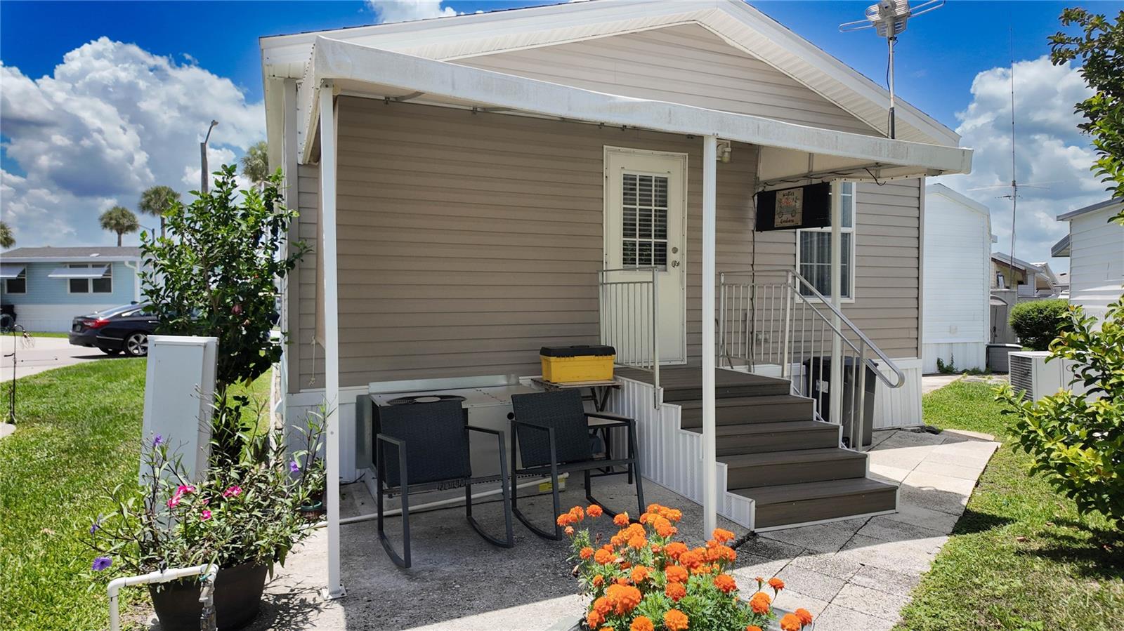Discover this beautifully updated, move-in-ready 2-bedroom, 2-bathroom double-wide home located in the highly desirable 55+ manned, gated community of Outdoor Resorts at Orlando. This thoughtfully renovated home features a bright, open floor plan and a modern kitchen complete with stunning quartz countertops, stainless steel appliances, stylish cabinetry, a vibrant tiled backsplash, and contemporary finishes—perfect for everyday living and entertaining. Both bathrooms have been tastefully remodeled, with the family bathroom featuring a laundry closet with full-size washer and dryer. The home also offers luxury flooring throughout, ceiling fans in the living room and both bedrooms, along with a newer roof and newer air conditioning system for added comfort and peace of mind. Outdoor living is just as impressive, with a covered rear patio ideal for relaxing or dining al fresco, and a dedicated golf cart parking pad or patio area to the left of the driveway, conveniently located in front of the entry steps. Outdoor Resorts is a golf cart-friendly, lakefront community on Lake Davenport, offering a 9-hole golf course, mini golf, two community pools, a clubhouse with planned social activities, multiple bathhouses, a dog park, a playground, and a community boat ramp with available slips. Ideally located just minutes from Walt Disney World and other Central Florida attractions, with easy access to Hwy 27, I-4, and SR 429. Nearby you'll find grocery stores, restaurants, shopping centers, and medical facilities, making this an ideal location for both full-time and seasonal living. Schedule your private showing today—this exceptional opportunity won’t last!