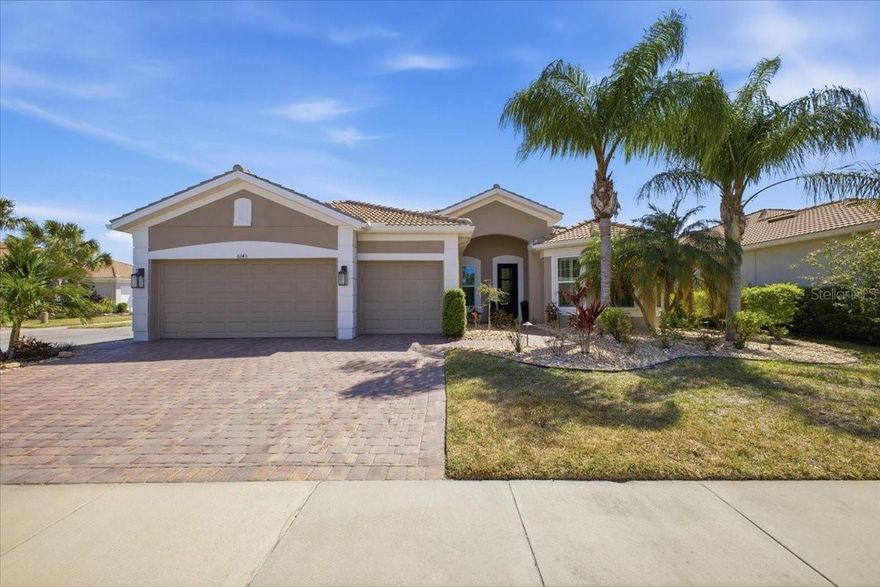 This exceptional home in The Isles of Palmer Ranch offers the perfect blend of luxury, comfort, and convenience, just minutes from grocery stores, beautiful Gulf beaches, and a wide selection of restaurants.  Nestled on a quiet cul-de-sac, the property boasts a rare, open backyard space that enhances both privacy and enjoyment.  Inside, the open-concept design seamlessly connects the kitchen, family room, and dining, highlighted by a stunning electric fireplace surrounded with cultured stone and a built-in 75" TV.  Upon entry, you're greeted by an exquisite bar room/office featuring custom cabinetry, a sink, refrigerator, ice maker, and a stylish Samsung Frame TV. The home includes three spacious bedrooms, custom wood cased openings and crown molding throughout, and an oversized three-car extended garage. Designed for Florida living, the outdoor area features a custom PebbleTec pool and spa set on a concrete base beneath elegant pavers, new pool pump and pool heater with a panoramic pool screen enclosure.  Additional upgrades NEW PGT IMPACT WINDOWS THROUGHOUT the entire home, a newly installed HVAC SYSTEM, an IRON IMPACT front door.  Automatic roll-down hurricane screens in the lanai, stunning V-groove wood ceiling, offering both beauty and peace of mind.