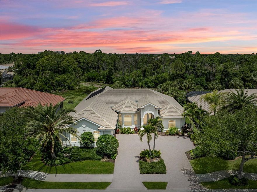 NEW ROOF IS CONTRACTED TO BE INSTALLED ON MAY 18TH. Set within the gated elegance of Venetia, this original-owner, custom-built Rossini II model offers a rare opportunity to own a home where thoughtful design, timeless craftsmanship, and everyday livability come together effortlessly. From the moment you arrive, a circular paver driveway and side-entry garage with windows create a striking first impression, while mature, beautifully maintained landscaping sets a tone of privacy and quiet sophistication. Step inside, and you’re immediately welcomed by crown molding and stunning tray ceiling details that draw your eye upward, adding dimension and character to the great room. A built-in glass shelving feature in the entry creates a refined focal point, while abundant natural light fills the home, softened by plantation shutters, custom drapery, and elegant valances throughout. As you move through the great room, your eye is naturally drawn beyond the interior to the beautiful pool and expansive lanai, creating an immediate connection to the home’s outdoor living space and setting the stage for effortless entertaining. Designed with both comfort and functionality in mind, the layout flows seamlessly between the great room, living room, and kitchen, with multiple sliders opening to the lanai for effortless indoor-outdoor living. The kitchen features wood cabinetry, a gas cooktop island, pineapple stained glass accents, expansive counter space, and generous seating at the breakfast bar. Just beyond, the sunlit eat-in area, highlighted by a signature “fishbowl” window, offers comfortable seating for four. The primary suite offers a spacious and private retreat, with French doors leading directly to the lanai. The en-suite bath features dual sinks, a jetted soaking tub, separate shower, and private water closet. Additional bedrooms provide flexibility for guests, a home office, or additional living space, including one with a built-in desk. Storage is a standout feature, with abundant closets throughout and many rooms offering dual closets. Step outside to a spacious lanai and beautifully designed pool featuring a linear spillover water feature, all overlooking tranquil pond views that create a peaceful backdrop for relaxing or entertaining. A dedicated pool bath adds convenience and functionality. This home also offers meaningful updates and peace of mind, including a new tile roof (2026), HVAC updates (2025 primary suite; 2018 main home), recent HVAC servicing (April 2026), and a pool resurfaced in 2025. A new whole-home automatic backup generator provides added confidence during unexpected outages. Additional features include a heated pool, hurricane protection, in-home vacuum system, irrigation system, and public water and sewer. Beyond the home itself, Venetia offers a resort-style lifestyle with a grand clubhouse, pool and spa, fitness center, tennis and pickleball courts, and a vibrant social calendar—all just a short walk from the home. Ideally located minutes from historic downtown Venice and the Gulf beaches, this home offers easy access to coastal living, waterfront dining, boutique shopping, and everything that makes Venice one of Southwest Florida’s most desirable places to call home.  ¤ Please see 3D Tour and Video ¤