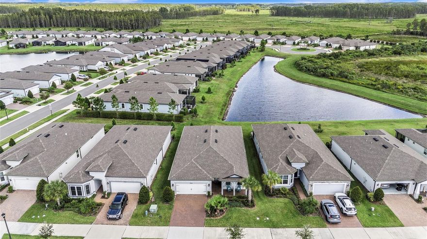 Stunning waterfront home in the premier Del Webb Bexley 55+ community! Offering a spacious open floorplan with custom neutral paint, luxury tile flooring, and high-end fixtures throughout, this is the home you have been waiting for and more. The modern kitchen is a chef’s dream, boasting upgraded appliances, 42" cabinetry with pull-out shelving, under-cabinet lighting, and an extended island with breakfast bar seating. Entertain with ease in the open-concept living and dining areas, which flow seamlessly out to a large, screened lanai—perfect for indoor/outdoor gatherings. An additional flex room with French doors provides a versatile space that can suit any of your household’s needs. Retreat to the spacious primary bedroom, complete with a luxurious en-suite bathroom featuring dual sinks and a large walk-in shower—your private oasis for starting and ending each day in serenity. Ideally located less than a mile from the expansive Del Webb amenity center, you’ll have access to multiple pools, a 19,000 sq. ft. clubhouse with fitness center and café, pickleball and tennis courts, a dog park, and countless social clubs. With close proximity to shopping, dining, medical facilities, and major highways, this home truly has it all. Don’t miss your chance—schedule your showing today!