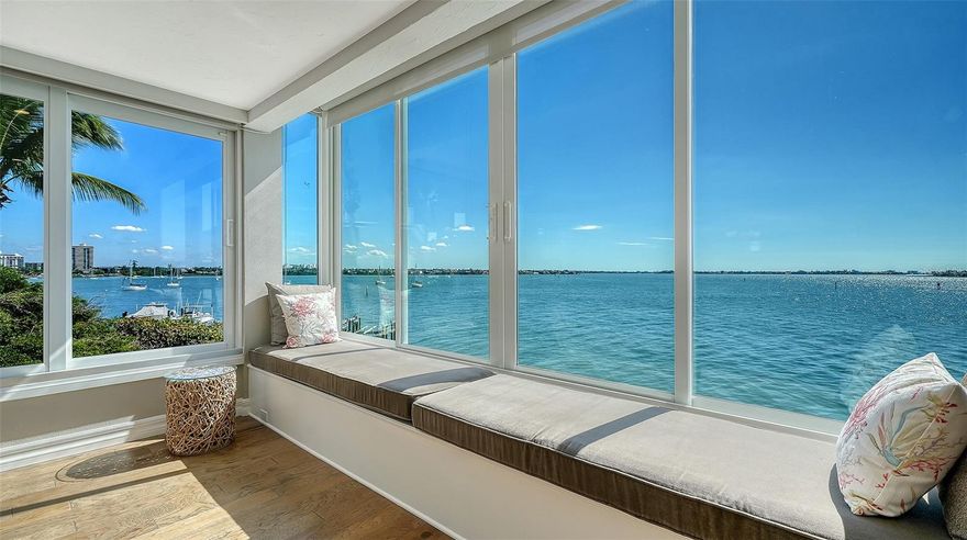 Experience Exquisite living at Harbor House South, where every moment is framed by breathtaking 180-degree Southerly views across Sarasota Bay. This stunning 3rd-floor, 2-bedroom, 2-bath end unit offers an expansive array of windows, the large one incorporates a cozy window seat that invites you to savor ever-changing vistas of the bay.

From the privacy of your home, witness marine wildlife, yachts, and sailboats gliding by, all while enjoying the stunning daily show of sunrises and sunsets. Elegant and thoughtfully designed, this home boasts high-end finishes including porcelain tile, crown molding, plantation shutters, solid core doors, and spa-inspired bathrooms.

Ideal for both entertaining and relaxation, the open and well-appointed floor plan features a spacious living and dining area, as well as a built-in office perfectly positioned to face the water. The chef's kitchen is a culinary dream with soft-close wood cabinets, quartz countertops, a state-of-the-art induction cooktop with stainless steel hood, a built-in convection oven, microwave, and a striking counter-to-ceiling glass-tiled accent wall.

Perfectly situated near Marina Jack, the Ringling Bridge, and Downtown Sarasota, this private oasis is just minutes from everything Sarasota has available. Discover the perfect blend of luxury, privacy, and convenience. Add this exceptional residence to your must-have list today!