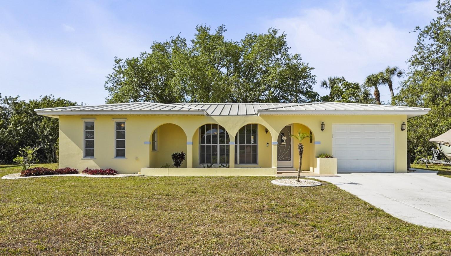 Your Florida Dream Starts Here – Over an Acre in a Waterfront Community!
This is where comfort, flexibility, and the Florida lifestyle all come together. This beautiful 2-bedroom, 2-bathroom home with a 1-car garage sits on just over an acre of land in one of Port Charlotte’s desirable waterfront communities. Even better, it includes a total of four lots, giving you the freedom to keep it as your private retreat or subdivide for future possibilities... or how about that big detached garage and workshop that you have always dreamed of !?!?
Step inside and you’ll immediately notice the bright, inviting feel of the home. In 2025, the living room received gorgeous new vinyl plank flooring, and the entire interior is completely carpet-free for easy maintenance. The kitchen features light wood cupboards and appliances, while fresh paint throughout gives the space a crisp, welcoming look. Both bathrooms have been refreshed with new vanities and toilets, and updated light fixtures add a modern touch.
This home is packed with upgrades that make it move-in ready and worry-free. The standing seam metal roof was installed in 2022, the hot water tank was replaced in 2021, and aluminum gutters were added for a polished finish. You’ll also appreciate the clear hurricane shutters and canvases that provide peace of mind during storm season. The garage comes with extra storage cabinets and includes a washer and dryer, making daily living even more convenient.
The enclosed lanai might just become your favorite spot in the house. Surrounded by tinted glass windows that open to enjoy the cool breeze and featuring classic terrazzo flooring, it’s perfect for morning coffee or evening relaxation.
Outside, the widened driveway offers plenty of space for your boat, RV, or extra toys, and with no HOA, you can truly enjoy your property your way. For boating enthusiasts, local ramps are just minutes away, making this a perfect spot for anyone who loves life on the water.
Whether you’re searching for a low-maintenance second home, an income-producing investment, or a property with room to grow, this one checks all the boxes. Don’t miss your chance to own over an acre of possibilities in sunny Port Charlotte!