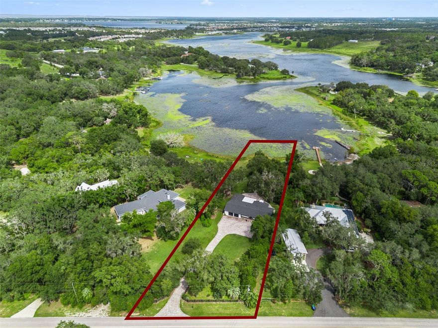 Modern Luxury Lakefront Living on Nearly 1.5 Acres in Winter Garden! Welcome to this fully remodeled, modern lakefront retreat on the shores of Lake Avalon, offering the perfect balance of sophistication, privacy, and convenience. Situated on almost 1.5 acres of fenced, irrigated land, this stunning single-story home features 3 bedrooms, 3.5 baths, and approximately 2,400 sq. ft. of living space with an attached 2-car garage—all meticulously updated with high-end finishes throughout. Step inside to an open, airy floor plan filled with natural light and luxury vinyl wood flooring that flows seamlessly from room to room. The gourmet kitchen is the heart of the home, featuring a dramatic quartz waterfall island, soft-close cabinetry, elegant gold accent hardware, and premium GE Cafe Matte white kitchen appliances, all included, along with washer and dryer. The kitchen overlooks a spacious dining area and family room, perfect for entertaining or relaxing by the wood-burning fireplace while taking in serene views of the backyard and lake beyond. The primary suite is a luxurious private retreat with two walk-in closets, direct access to the back porch, and a spa-style bathroom featuring double vanities, a beautifully tiled walk-in shower, and a freestanding soaking tub. The two additional bedrooms each have their own custom; modern bathrooms designed with premium tile and fixtures. Outside, the possibilities are endless. Enjoy the peaceful setting surrounded by mature trees, a large fire pit area, and a private pathway leading to your own dock—perfect for fishing, kayaking, or simply watching the sunset over the lake. The property offers ample space for a boat, RV, or multiple vehicles along the extended paved driveway, with no HOA restrictions, allowing you the freedom to add a guest house, barn, or workshop if desired.Major updates include: Roof (2021), A/C (2021), Water Heater (2020), Windows (2019), Water Softener & Purification System (2021). The home operates on well and septic, ensuring low utility costs and self-sufficiency. Located just minutes from Historic Downtown Winter Garden, Fowler’s Grove, and Hamlin Town Center, you’ll enjoy the best of both worlds—city conveniences with a peaceful, country feel. This home truly has it all: acreage, lake access, privacy, and luxurious modern design—all move-in ready for the holidays. There’s simply nothing else like it on the market. Come experience lakefront living at its finest in one of Central Florida’s most desirable locations.Call Denise Gregorie, Clock Tower Realty, for your private tour today!