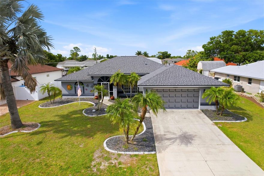 This beautifully maintained pool home in Port Charlotte offers outstanding curb appeal, enhanced by lush tropical landscaping, swaying palm trees, and a clean, modern exterior. The 3-bedroom, 2-bath residence with a 2-car garage provides 1,695 square feet of thoughtfully designed living space, ideal for both comfortable everyday living and effortless entertaining. Inside, the spacious floor plan features separate formal living and dining rooms, highlighted by soaring ceilings and an open, airy design that creates an immediate sense of warmth and welcome. Sliding glass doors seamlessly extend the living areas to the pool, perfectly embracing Florida’s indoor-outdoor lifestyle. Abundant natural light, attractive flooring, and a versatile layout create an inviting atmosphere for relaxing or hosting family and friends. The kitchen serves as a true focal point of the home, showcasing rich natural wood cabinetry, a closet pantry for added storage, and granite countertops that provide generous prep space. Stainless steel appliances—including a French-door refrigerator and built-in microwave—add a sleek, modern touch, while recessed lighting and stylish ceiling fixtures keep the space bright and functional. Wood flooring continues into the sunlit dinette area, where sliding glass doors open directly to the lanai and pool, allowing for effortless flow between indoor and outdoor spaces. Just off the kitchen, the well-equipped laundry room offers convenience and functionality with a washer and dryer, utility sink, and additional cabinetry. Direct access to the garage simplifies daily routines and household tasks. Privately situated on its own side of the home, the primary suite offers peaceful retreat and direct access to the pool. The spacious walk-in closet and luxurious en-suite bath complete the experience, featuring a large dual-sink vanity with ample storage, decorative mirrors, and natural light from an oversized arched window. A walk-in tiled shower, relaxing garden tub, and separate private water closet create a spa-like atmosphere. Two well-appointed guest bedrooms are located on the opposite side of the home, each offering plush carpeting and built-in closets. A spacious guest bathroom conveniently serves both rooms, making the layout ideal for family and visitors alike. Step outside to enjoy true Florida living in the private backyard oasis. A sparkling swimming pool is enclosed within a large, screened lanai, offering shaded comfort and refreshing airflow thanks to ceiling fans. With plenty of space for lounging, dining, and entertaining, this inviting outdoor area is perfect for hosting gatherings or unwinding poolside. Beyond the lanai, the fully fenced backyard adds privacy and security and includes a convenient 10x12 storage shed—ideal for tools, bikes, or beach gear. Open views and abundant natural light create a bright, serene extension of the home. Additional recent updates include a new roof in 2022 and a new A/C system in 2024. Perfectly located in the heart of Port Charlotte, this home offers easy access to shopping, dining, and outdoor recreation, including Bayshore Live Oak Park and Port Charlotte Town Center. With convenient access to Interstate 75 and just a short drive to the airports in Punta Gorda and Fort Myers, this location combines everyday convenience with easy travel and the best of Southwest Florida’s coastal lifestyle. **PLEASE ENJOY THE 3D INTERACTIVE VIRTUAL TOUR ASSOCIATED WITH THIS LISTING**