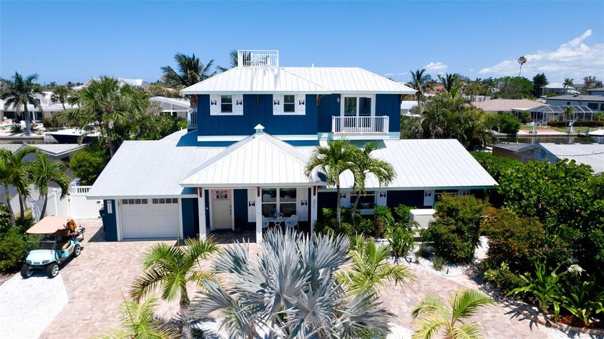 Experience the ultimate island lifestyle in this exquisite coastal retreat on Anna Maria Island. Nestled on one of the island’s most breathtaking tropical lots, this beautifully updated four-bedroom, three-and-a-half-bath residence offers deepwater canal access to the Gulf and the perfect blend of luxury, comfort, and waterfront living.  Sold fully furnished and including a golf cart for added convenience, the home underwent an extensive remodel in 2021 and has been thoughtfully upgraded throughout. Recent improvements include a new seawall and dock with a 10,000-pound boat lift upgraded in 2024, as well as a whole-house propane generator installed in 2026. The property has also had no flood damage.
Inside, expansive wood-look plank tile flooring creates a warm and inviting atmosphere throughout the home. The stunning chef’s kitchen features quartz countertops, custom cabinetry, and premium high-end appliances. The main living level includes three spacious guest bedrooms, while the entire upper level is dedicated to a luxurious primary suite complete with dual vanities, a spa-inspired bathroom, and an oversized walk-in closet with washer/dryer.
Additional highlights include a 200-square-foot insulated storage attic, a private man cave, and a unique indoor entertainment space featuring an indoor grill, bar, and television area that flows seamlessly to the resort-style pool and outdoor living space.
From your private dock, enjoy direct boating access to nearby beaches, waterfront dining, and all the charm that island living has to give.
This exceptional property is a rare opportunity to own a true waterfront paradise on one of Florida’s most sought-after islands. Don’t miss your chance to make this dream home your reality.