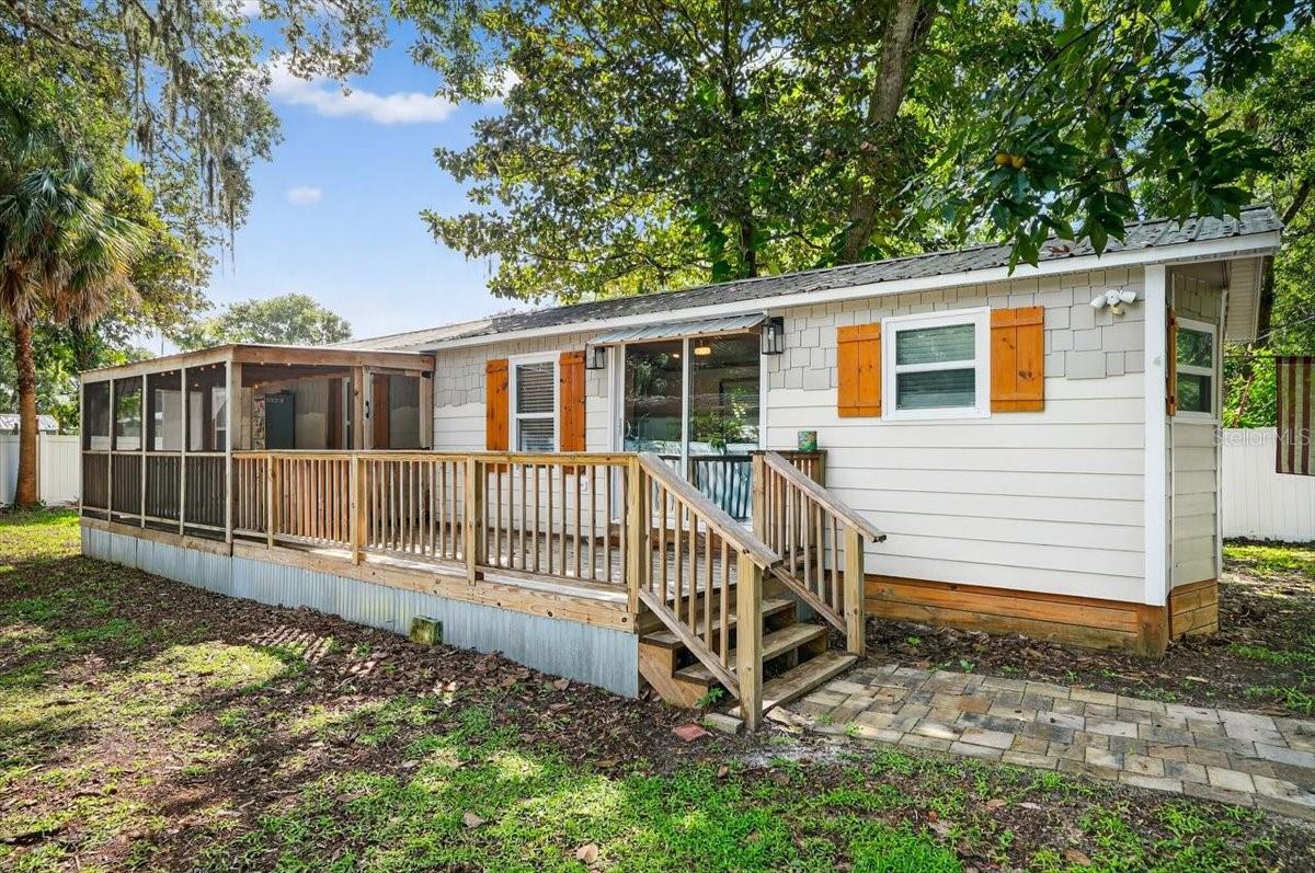 Discover a fully remodeled 2-bedroom, 2-bathroom manufactured home in the heart of Palm Coast’s Hammock Peninsula, offering a modern beachside retreat that feels like a true home. This stunning property boasts a complete interior transformation, featuring spray foam insulation capsulizing the structure and new windows and sliders for energy efficiency, and a new water filtration system. The spacious, open layout makes living easy and complemented by a large front porch, both open and screened, perfect for relaxing or entertaining. The PVC-fenced property includes a private entry gate, ensuring seclusion and charm. Ideal for investors seeking long-term or short-term rental opportunities or as a personal coastal escape, this home is just a bike ride from pristine beach access. Enjoy the convenience of nearby Hammock restaurants and shopping, with vibrant downtown Flagler Beach a short drive south and historic St. Augustine is just a short drive to the north. Embrace the perfect blend of modern comfort and coastal living in this exceptional Hammock Peninsula gem.