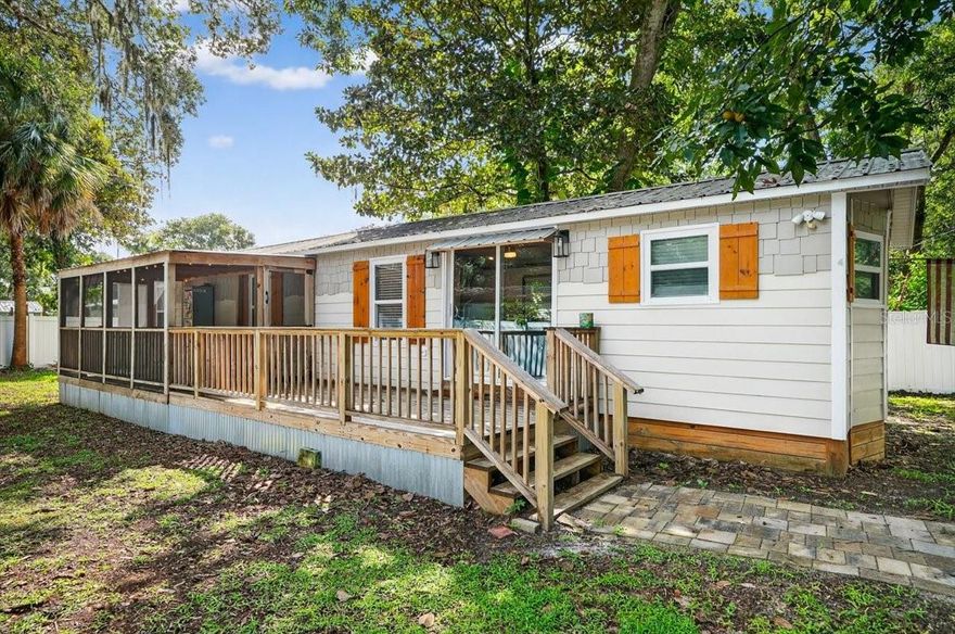 Discover a fully remodeled 2-bedroom, 2-bathroom manufactured home in the heart of Palm Coast’s Hammock Peninsula, offering a modern beachside retreat that feels like a true home. This stunning property boasts a complete interior transformation, featuring spray foam insulation capsulizing the structure and new windows and sliders for energy efficiency, and a new water filtration system. The spacious, open layout makes living easy and complemented by a large front porch, both open and screened, perfect for relaxing or entertaining. The PVC-fenced property includes a private entry gate, ensuring seclusion and charm. Ideal for investors seeking long-term or short-term rental opportunities or as a personal coastal escape, this home is just a bike ride from pristine beach access. Enjoy the convenience of nearby Hammock restaurants and shopping, with vibrant downtown Flagler Beach a short drive south and historic St. Augustine is just a short drive to the north. Embrace the perfect blend of modern comfort and coastal living in this exceptional Hammock Peninsula gem.
