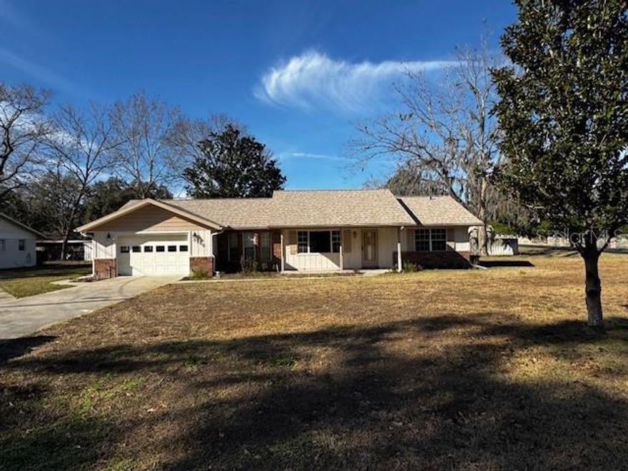 Old-School Charm with Peace of Mind! This well-built, well-maintained, well-located home was solidly constructed in 1986 and has been thoughtfully updated where it matters most. Nestled in a quiet neighborhood on the outskirts of town, the home offers a peaceful setting while remaining conveniently close to shopping, dining, and everyday essentials. This 3 bedroom, 2 bath home still carries some of its original character- like classic floor heaters that nod to a time when homes were built to last. Beneath the vintage touches is a structurally sound, thoughtfully maintained property with all the major updates already completed. This move-in-ready home offers recent 2024 updates, including a brand-new roof, new flooring, fresh interior paint in most of the home, updated kitchen countertops, new ceiling fans, and new kitchen appliances. For added peace of mind, all plumbing valves and fixtures have been replaced, along with a new garage door motor and remote. Enjoy the large screened lanai, which leads to a fenced back yard for the family to enjoy, and an attached carport on the back of the home for additional parking. Enjoy the convenience of community water for everyday use, along with a private irrigation well that helps keep the lawn looking its best while providing an efficient way to maintain the yard year-round. While some cosmetic elements remain ready for a personal refresh, this home offers a rare opportunity to blend timeless charm with your own modern style. A solid foundation, dependable systems, and the freedom to make it uniquely yours.