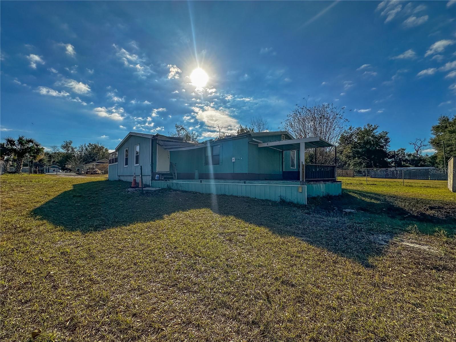 Discover the potential of this 3 bedroom 2 bathroom manufactured home with a garage, located on a large fenced in corner lot, in the community of Skyline Hills in Lady Lake.
Located a short drive away from an array of shopping, dining and other amenities this home offers the convenience of town living with the privacy of your own outdoor space.
Ask about Renovation Loan options to wrap in repairs and renovations into your loan.