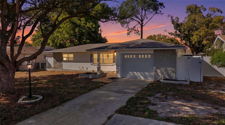 Welcome to 2190 Scotland Drive in Clearwater, a beautifully updated 3-bedroom, 2-bathroom home with a 1-car garage offering 1,251 square feet of comfortable living space and a spacious, New Vynl fully fenced backyard. Inside, you’ll find a bright and inviting open layout with updated flooring and abundant natural light throughout. The living room flows seamlessly into the dining area and kitchen, creating an ideal setup for both everyday living and entertaining. The kitchen is a standout feature, showcasing modern white cabinetry, sleek countertops, stainless steel appliances, and a large island with a statement range hood, providing both style and functionality. The primary bedroom is generously sized with great natural light, while the additional bedrooms offer flexibility for guests, family, or a home office. Both bathrooms have been updated with clean, modern finishes, including a stylish tiled walk-in shower. Step outside to enjoy the covered patio, perfect for relaxing or hosting, overlooking a private, fenced backyard with plenty of space for pets, play, or future outdoor enhancements. A storage shed adds extra convenience. Located in a desirable Clearwater area, this home offers easy access to shopping, dining, and Gulf beaches while maintaining a quiet residential feel. A move-in ready home combining modern updates, functional layout, and great outdoor space—schedule your showing today!